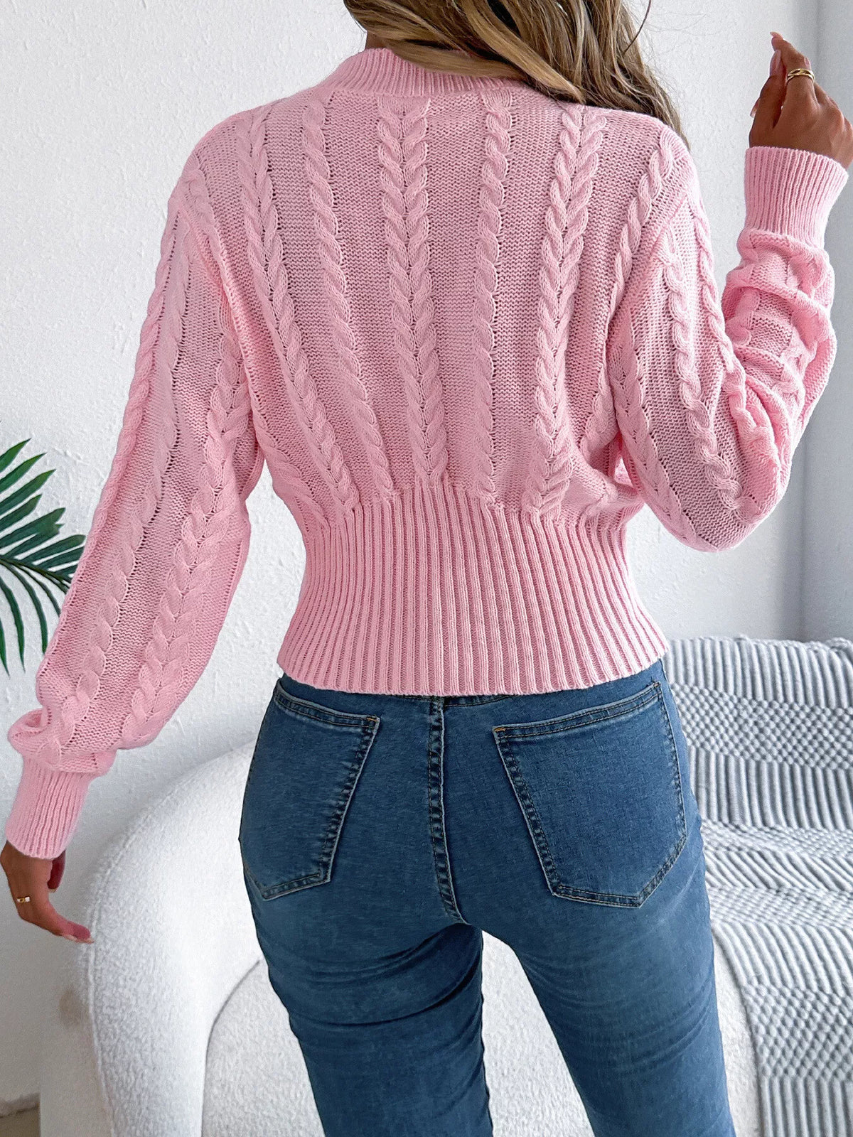 Pink cable knit mock neck sweater, back view