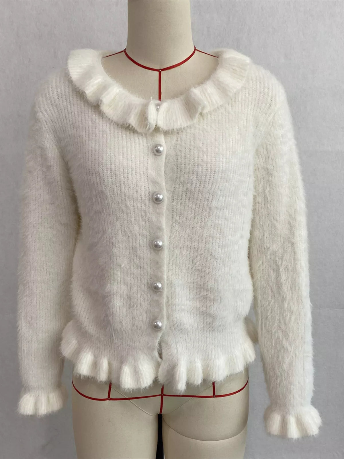 Ivory fuzzy ruffle-trim button-front cardigan, front on dress form.