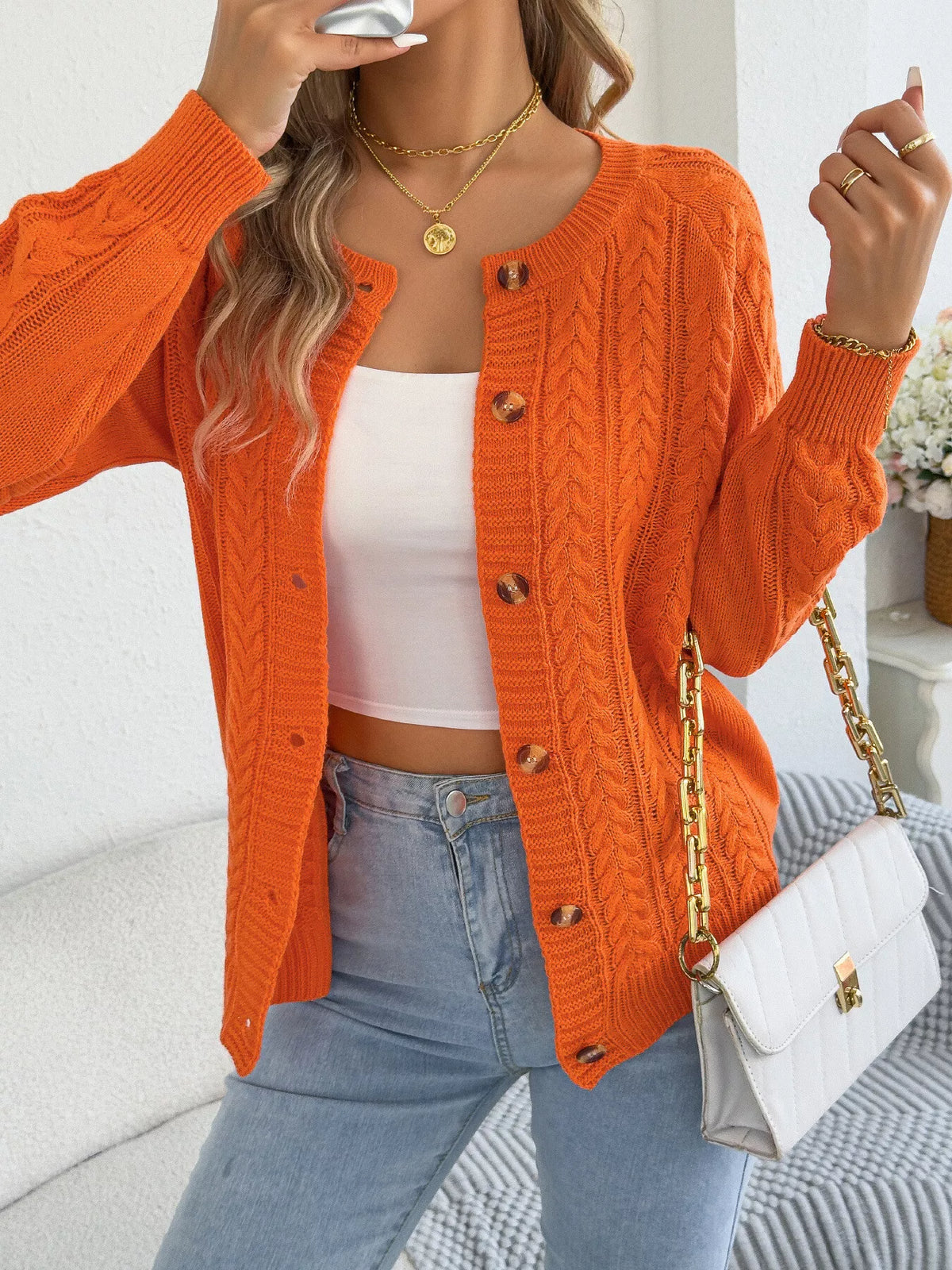 Orange cable knit button-front cardigan