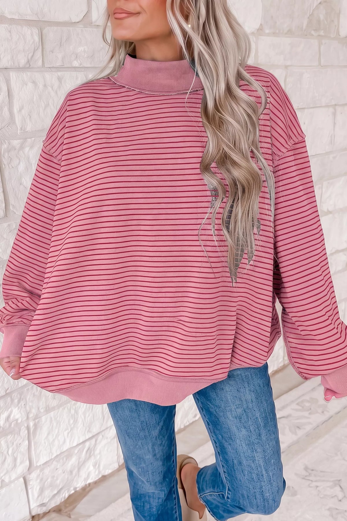 Pink and red striped striped color-block mock neck sweatshirt — front view