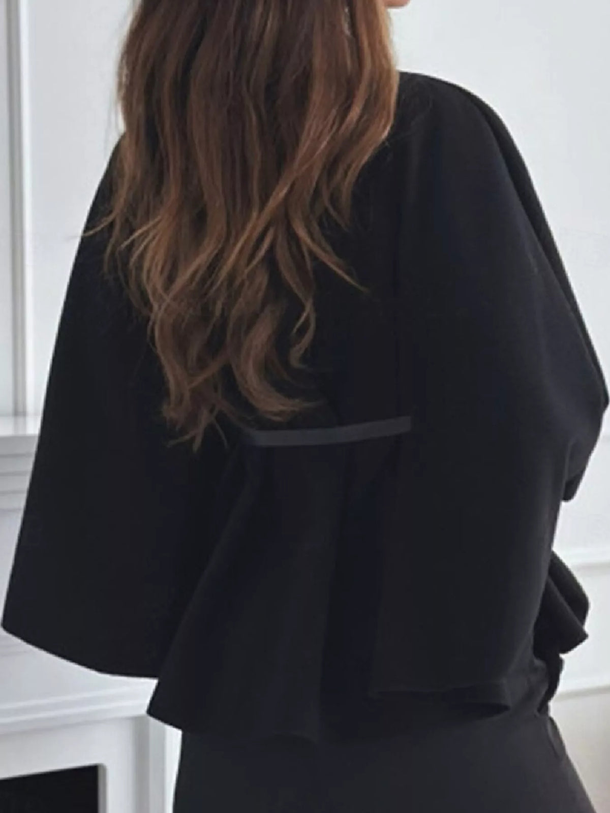 Belted Mock Neck Cape in black, back view