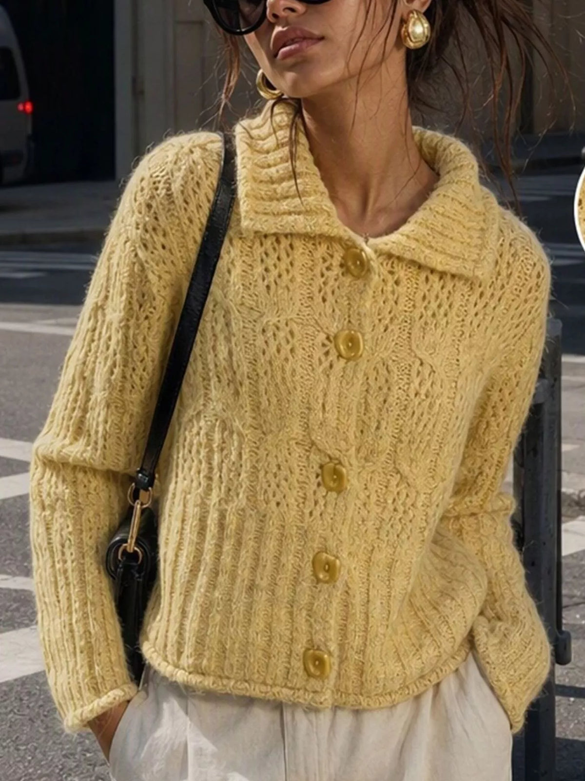 Yellow cable-knit collared button-front cardigan, front view.