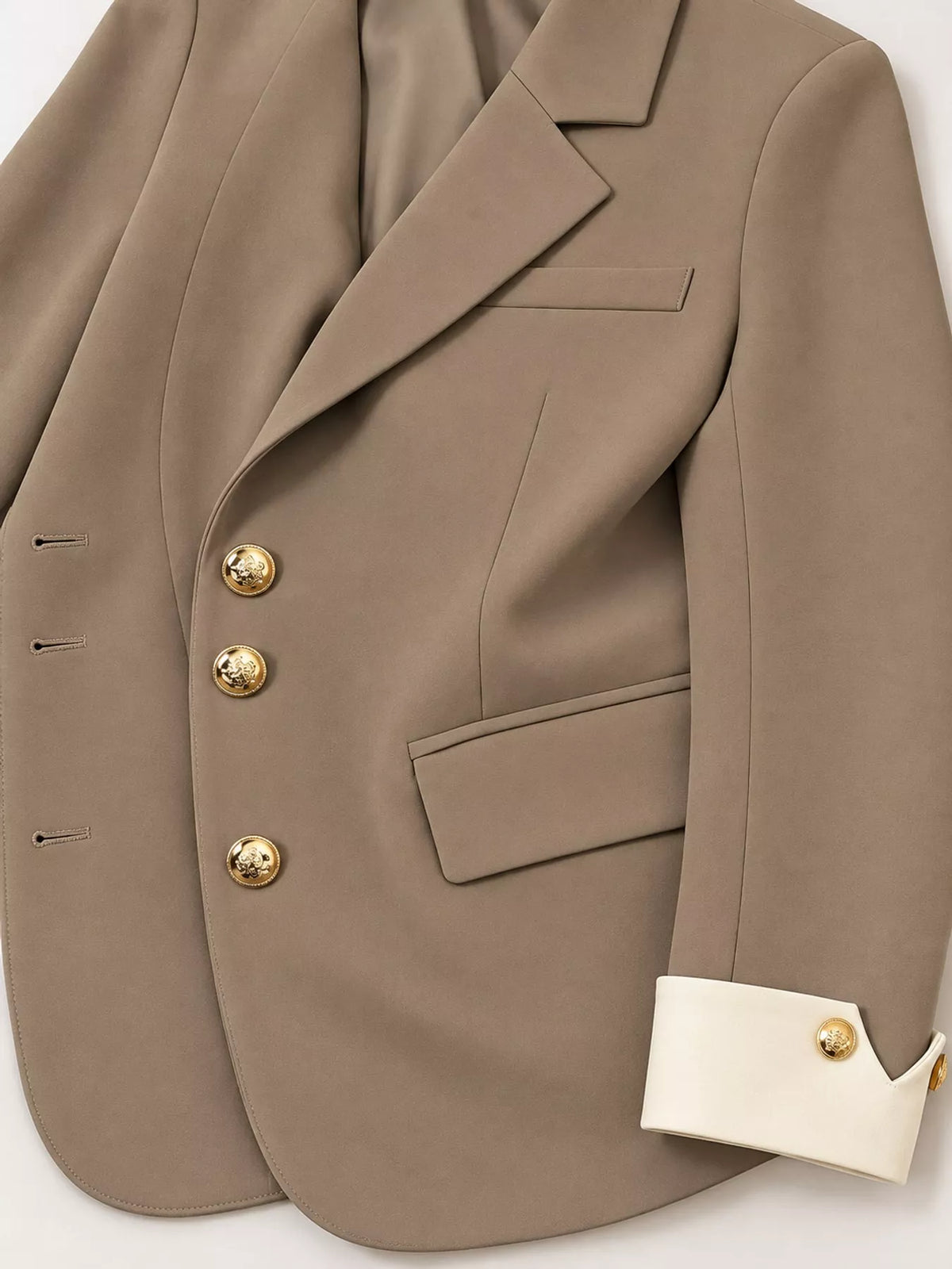 Taupe single-breasted blazer with gold-tone buttons, lapel, pocket, buttons, and contrasting cuff
