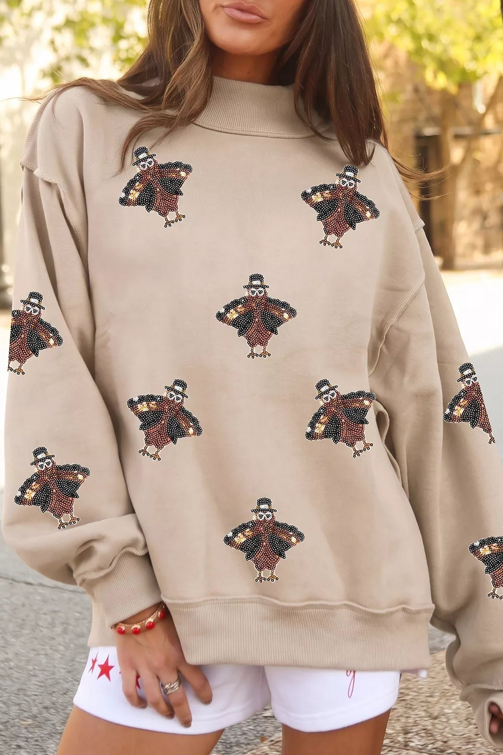 Sequin turkey mock-neck exposed-seam sweatshirt