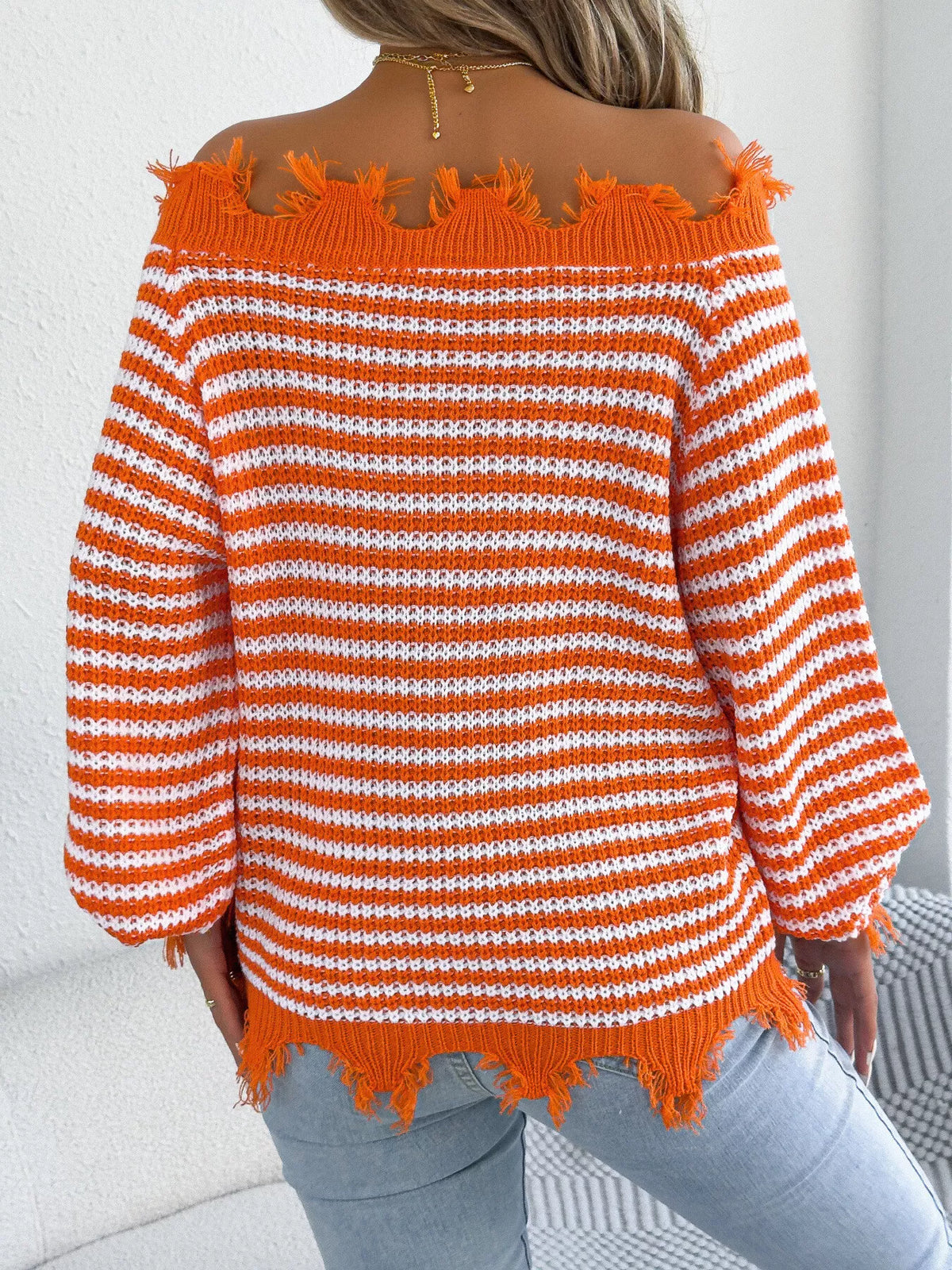 Orange off-shoulder frayed hem striped sweater, back view