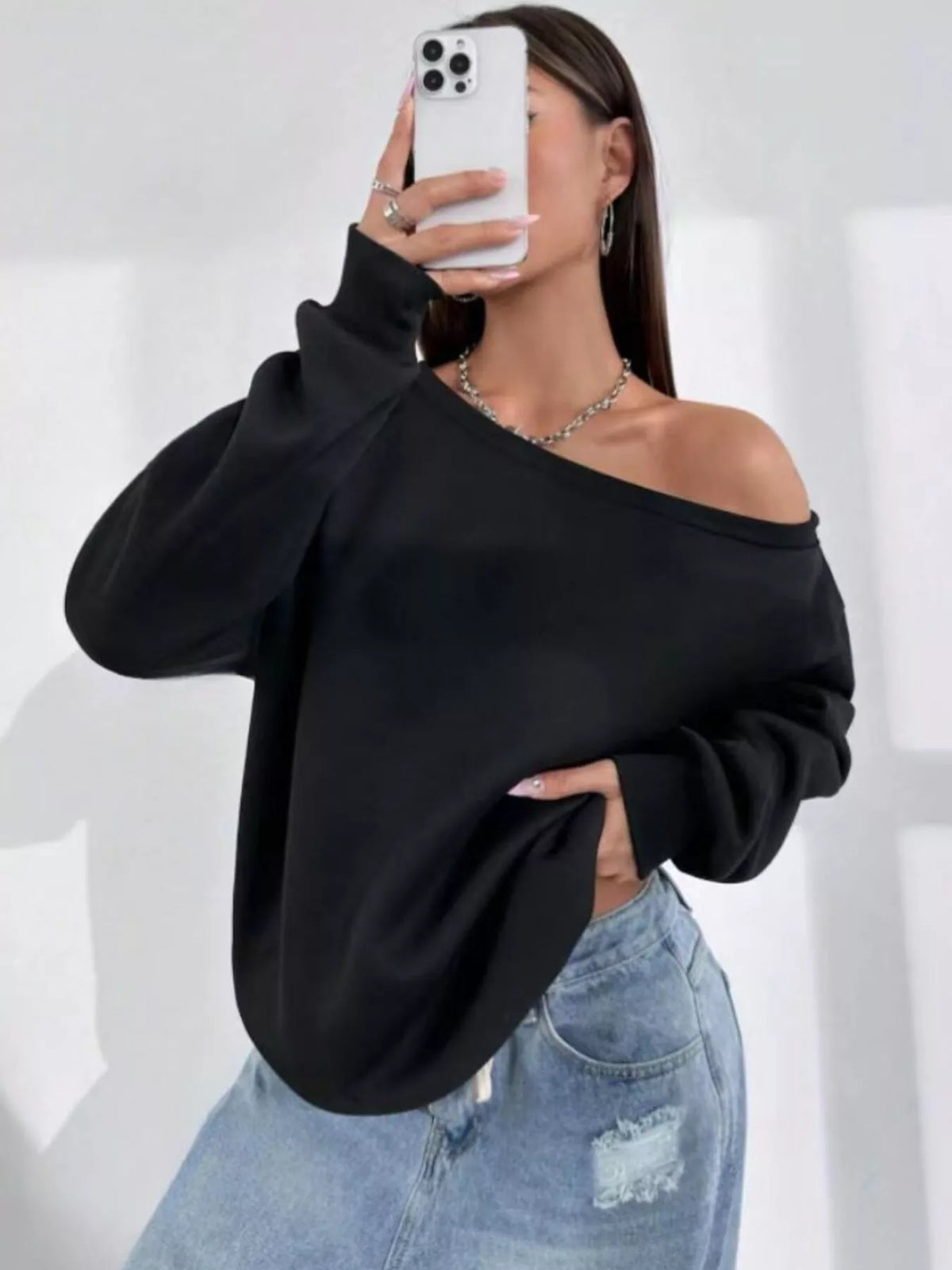 Black asymmetric-neck sweatshirt, front mirror view
