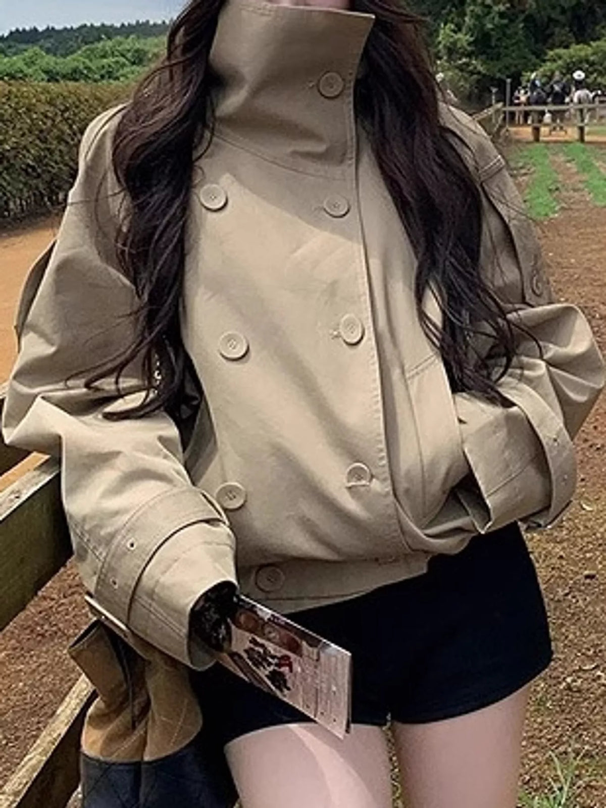 Beige double-breasted cropped trench jacket, button front view