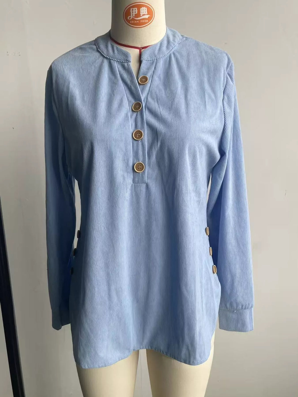 Light blue button detail long sleeve top, front view