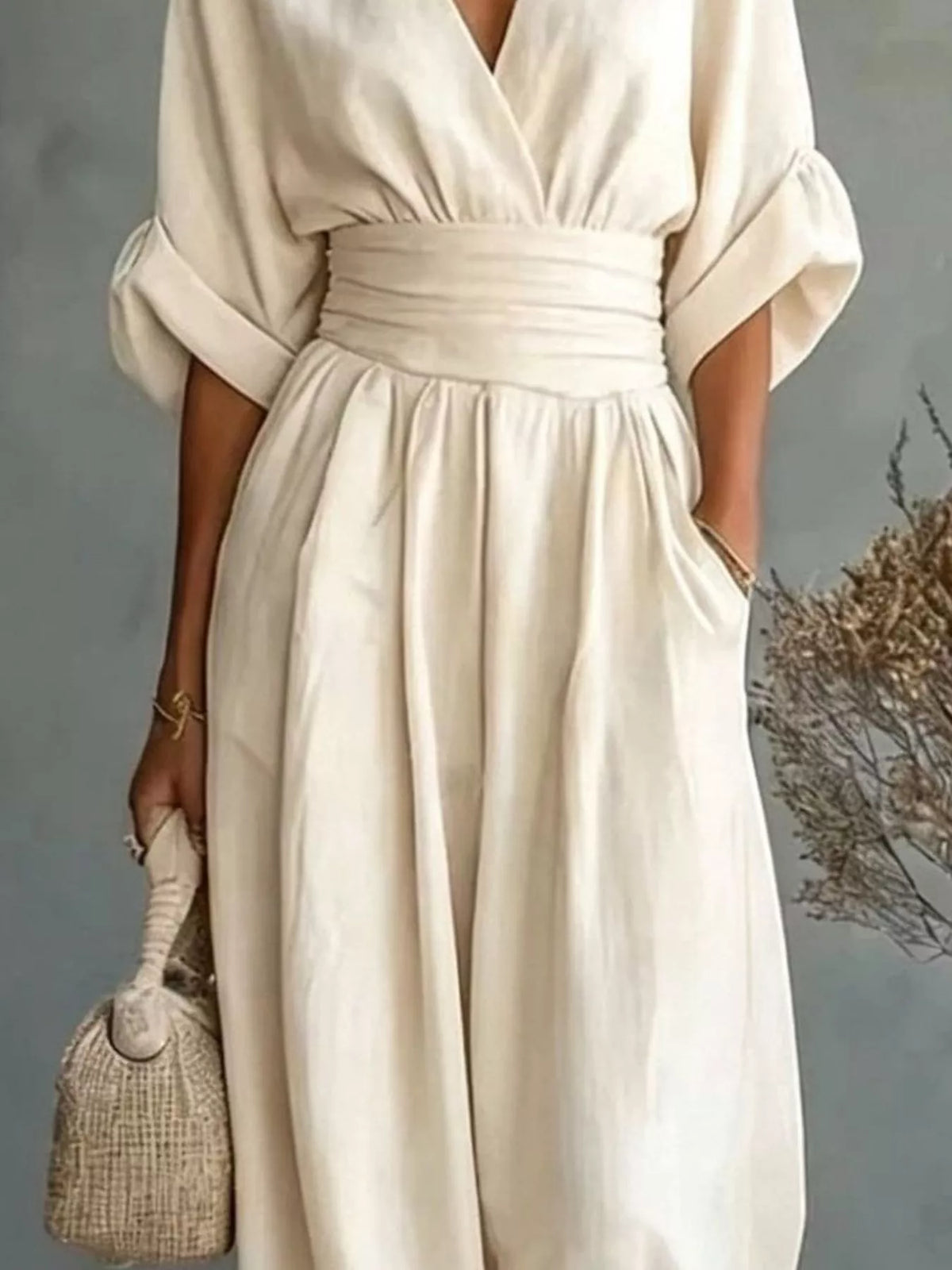 Cream V-neck wide-leg jumpsuit, waist and sleeve detail
