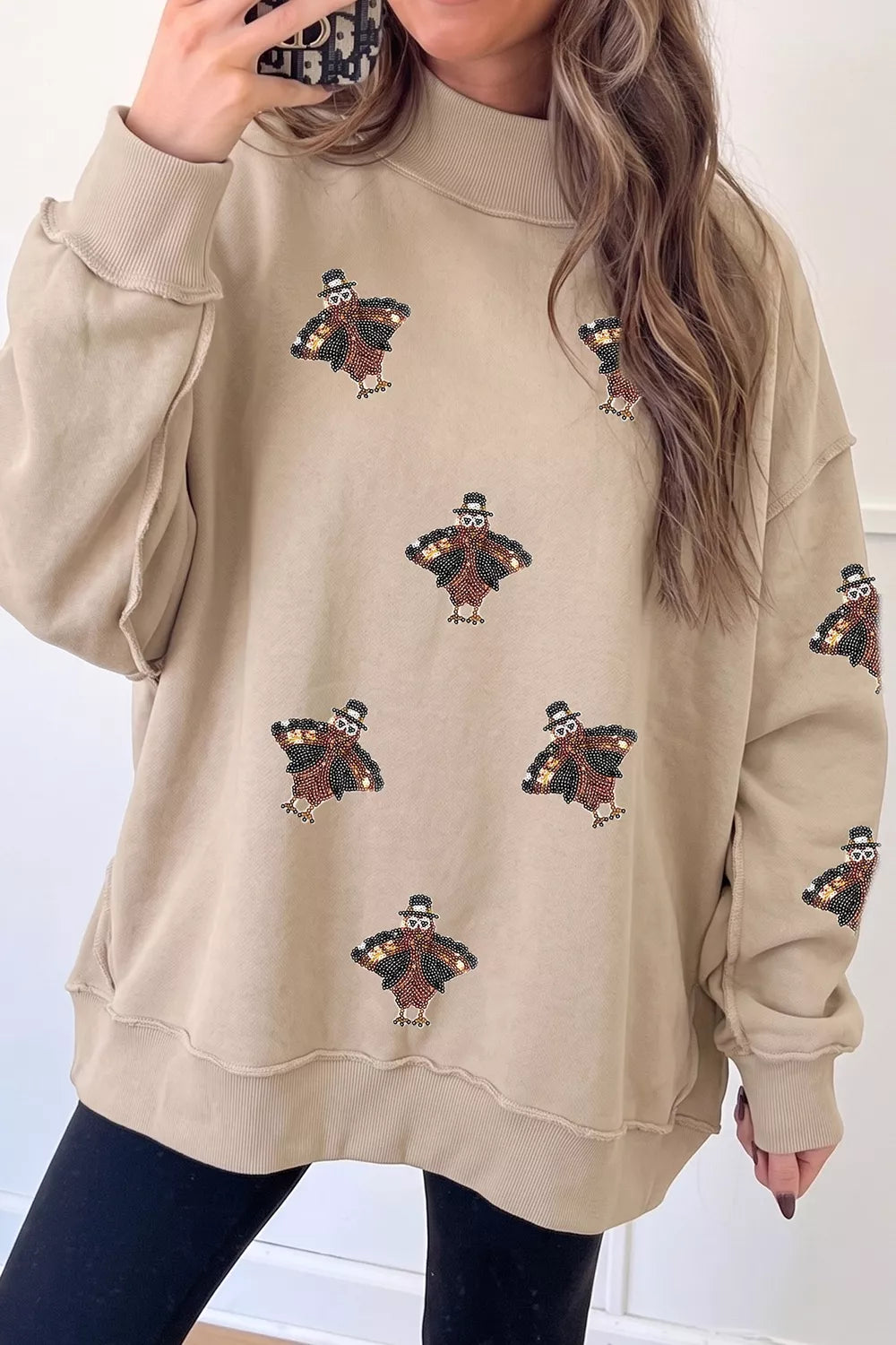 Sequin turkey mock-neck exposed-seam sweatshirt