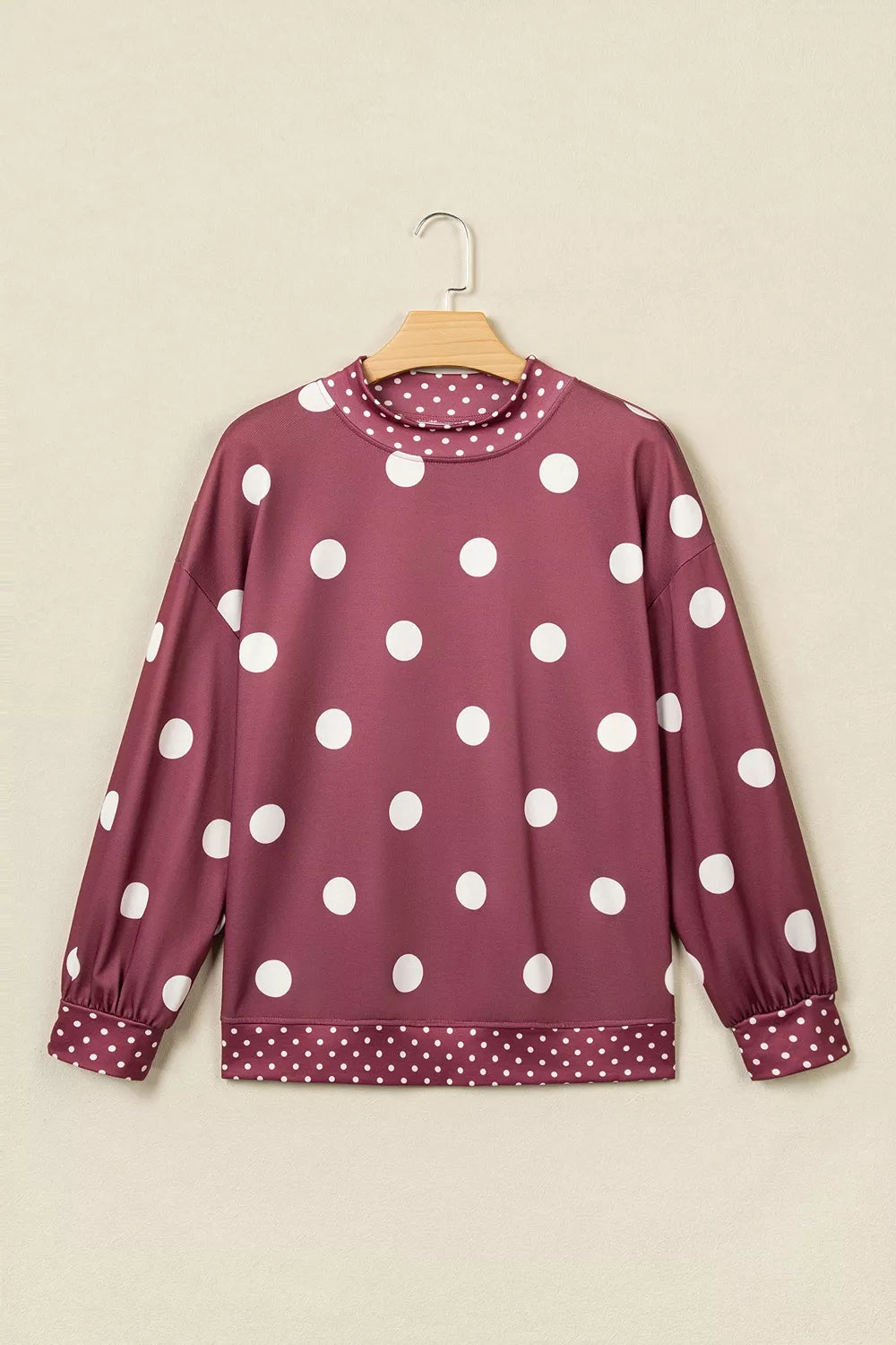 Burgundy polka dot tunic sweatshirt, front on hanger