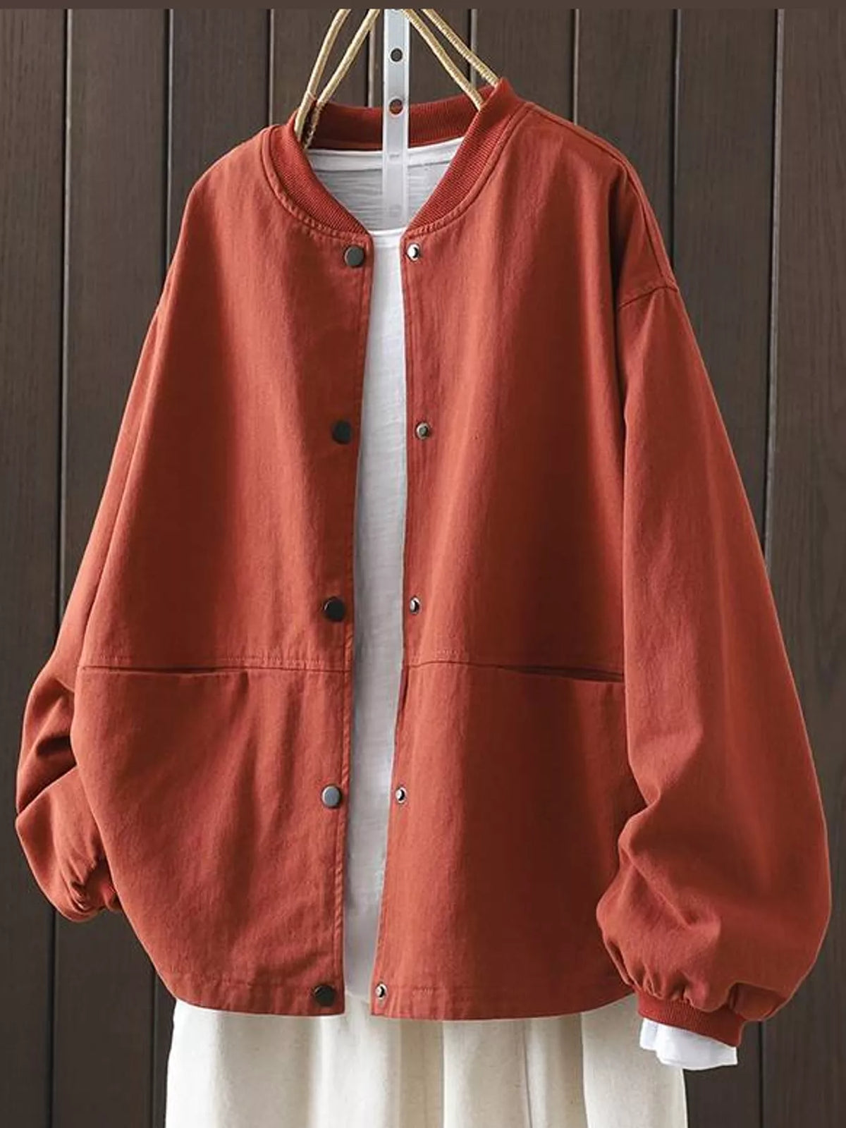 Rust red snap front dropped shoulder jacket, front view