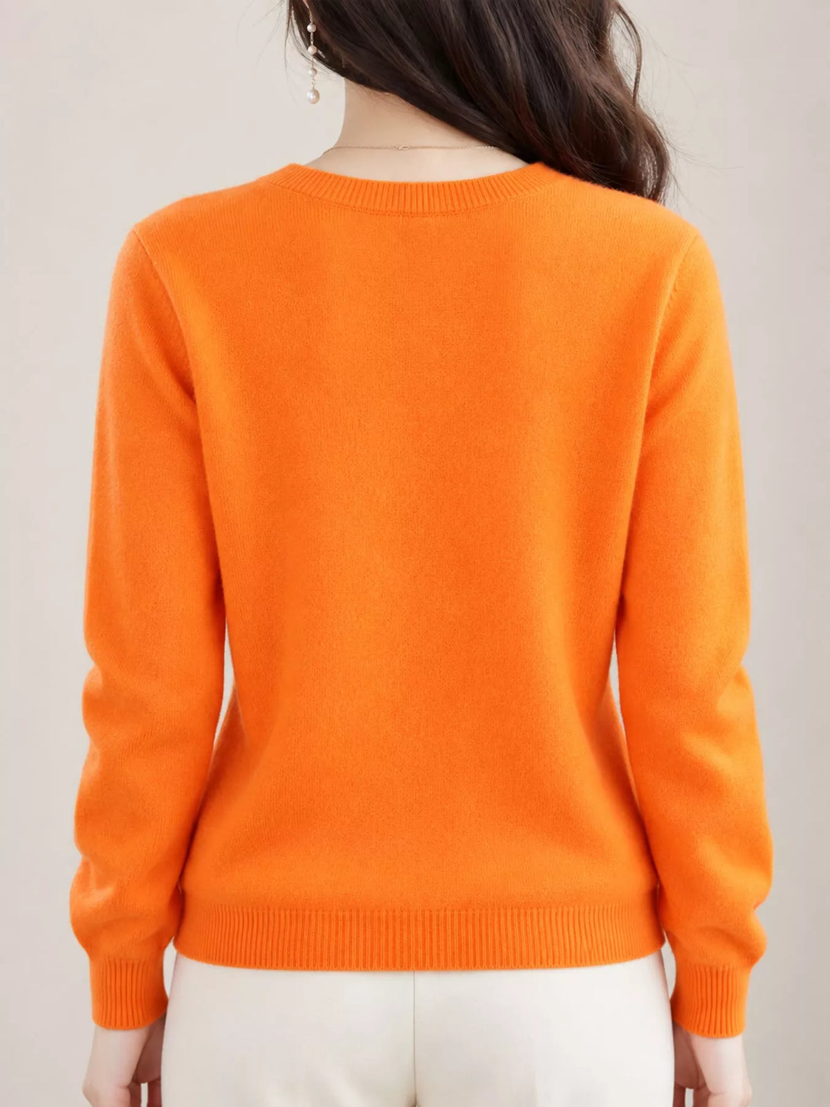 Orange crew neck button-front cardigan, back view