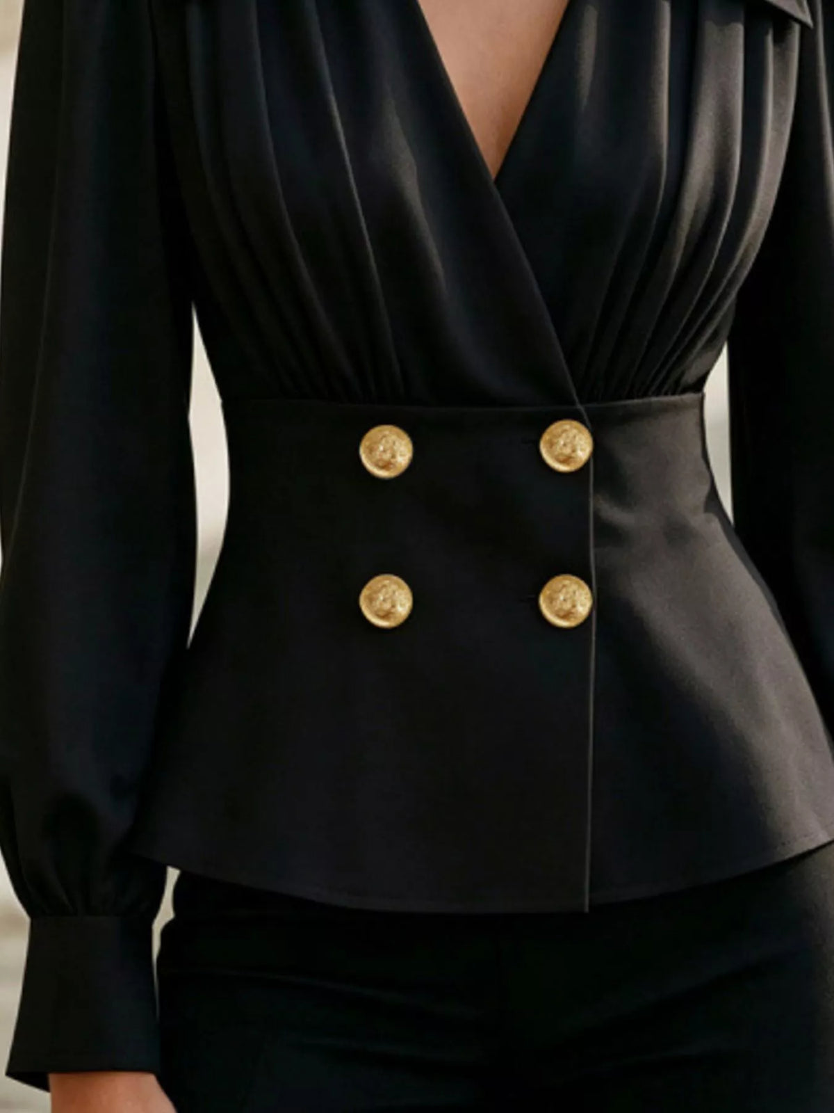 Double-breasted peplum blouse in black, waist and button detail