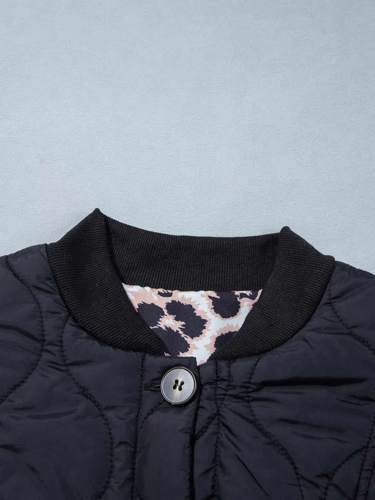 Quilted Leopard Cuff Button Down Puffer Jacket in black, construction detail