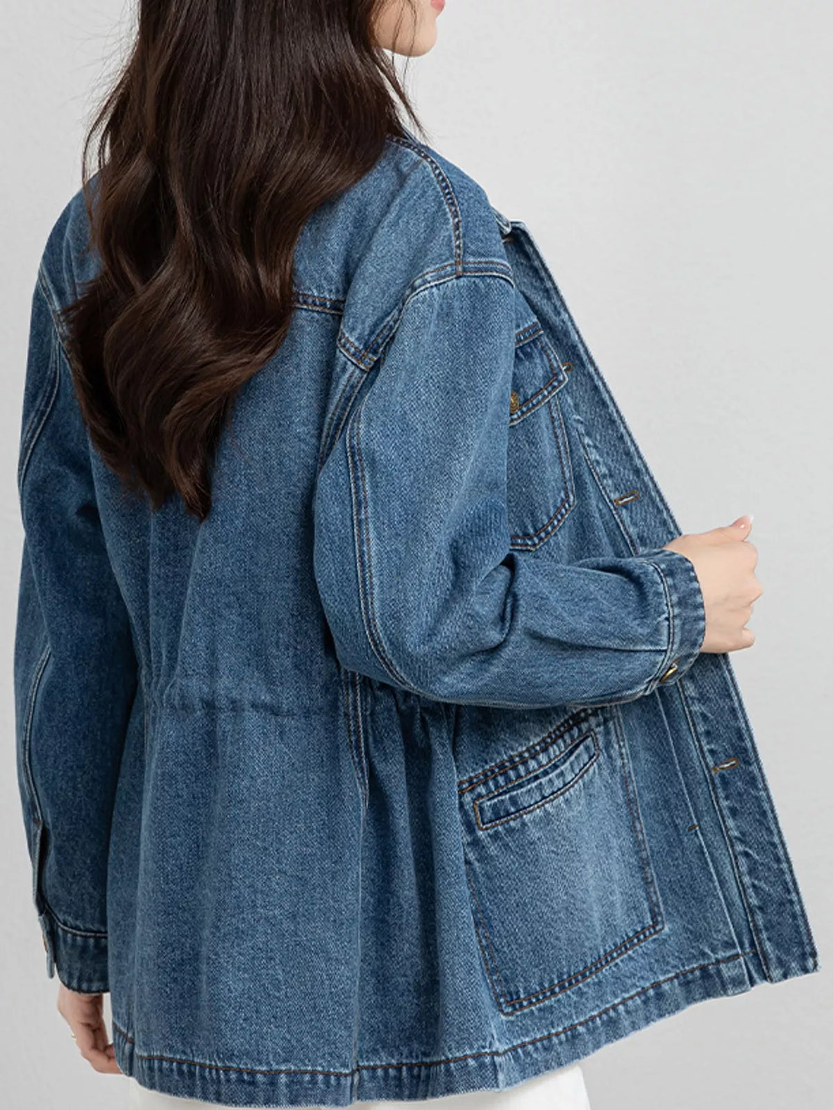Blue button up long sleeve denim jacket, back view