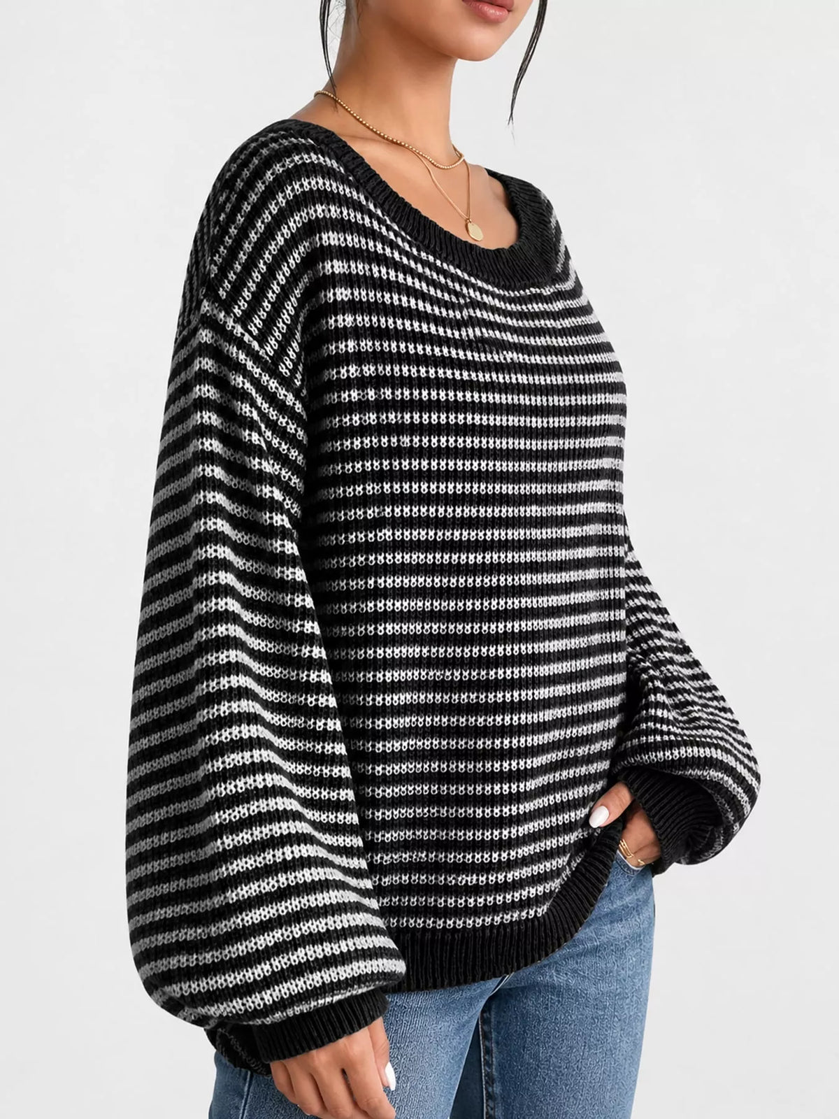 Black and white striped knit boat neck sweater, side view