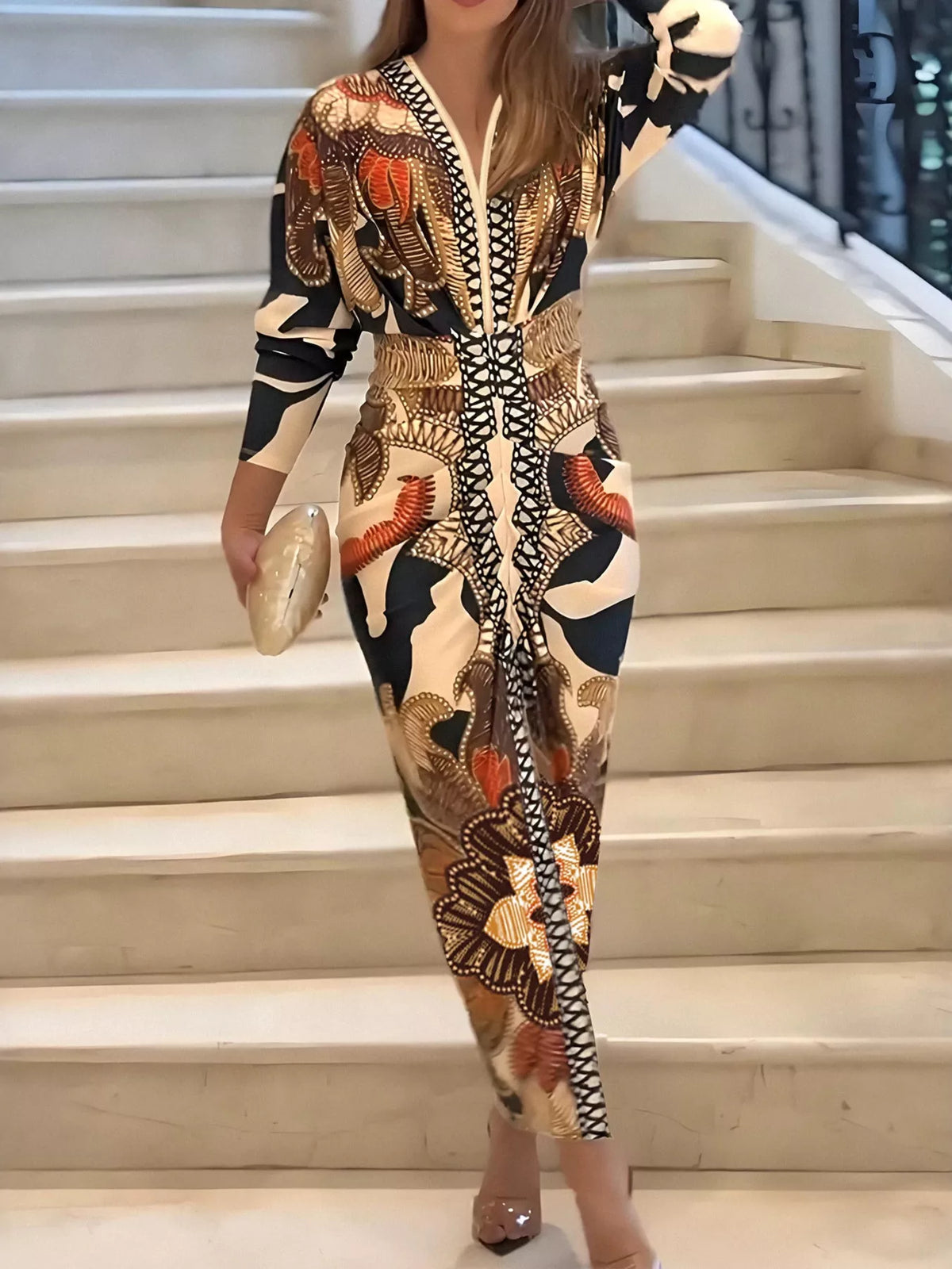 Orange, black and cream printed slit long-sleeve dress, front view on steps