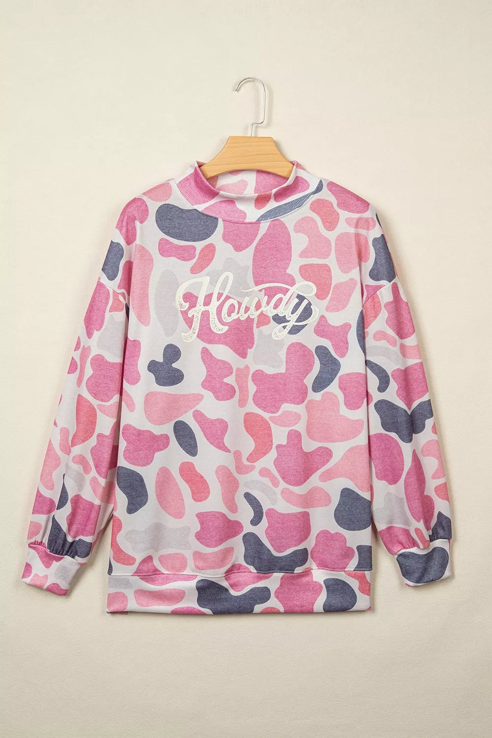 Pink camouflage Howdy sweatshirt, front on hanger