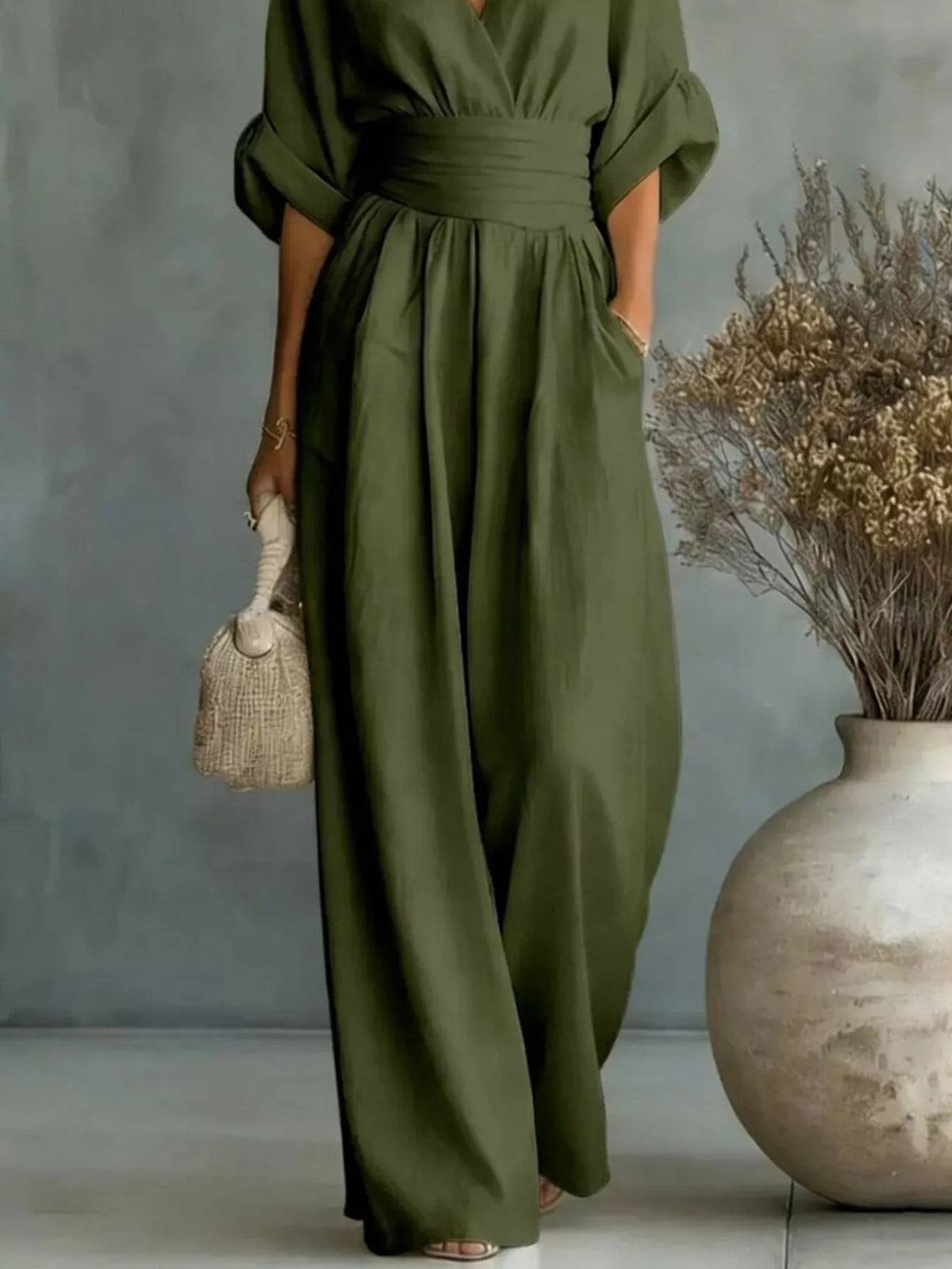 Olive green V-neck wide-leg jumpsuit, waist and leg detail