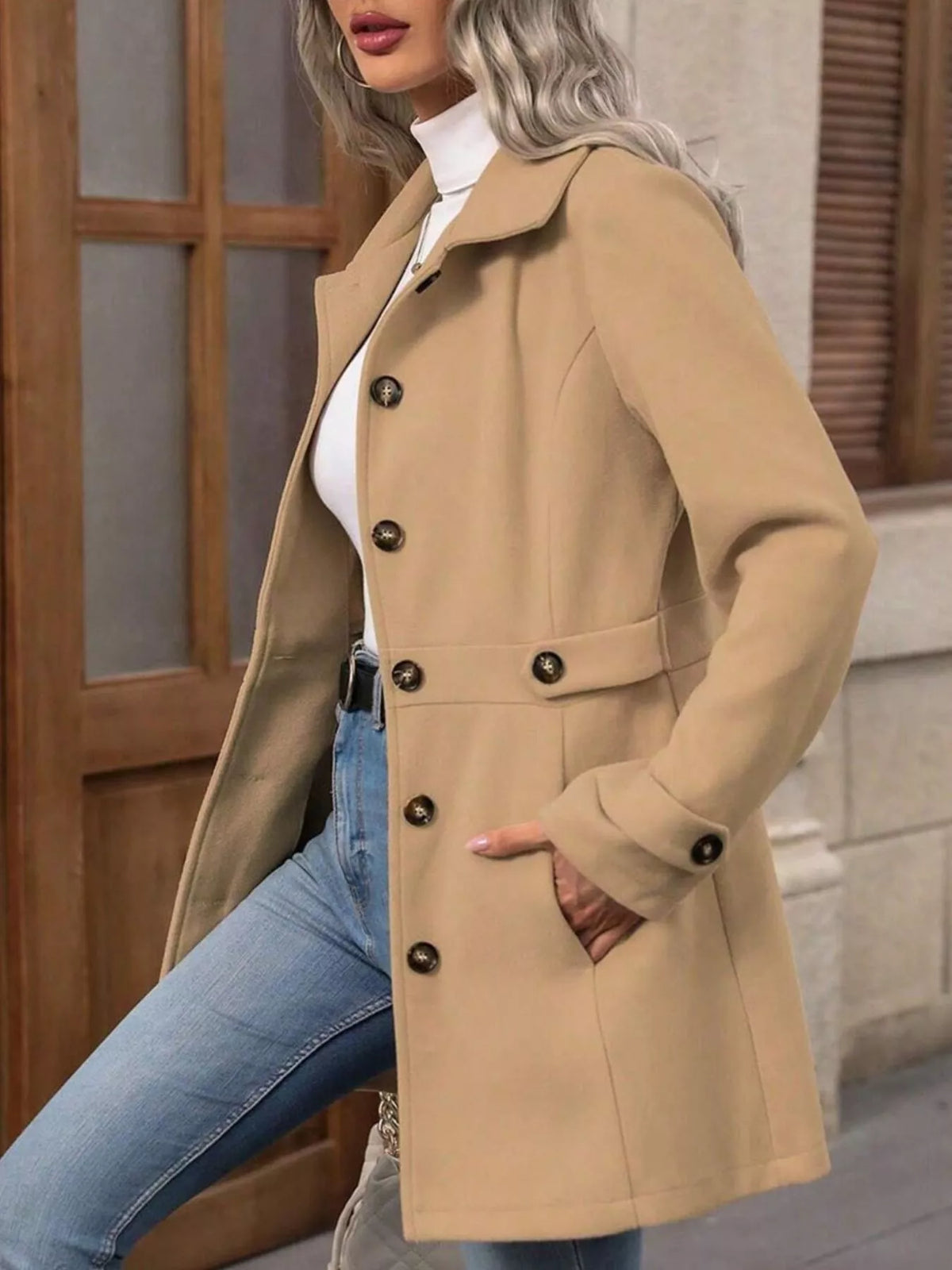 Camel single-breasted coat, side view with one knee bent