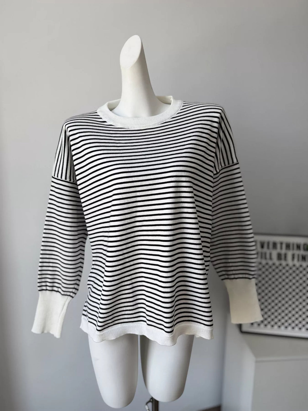 Striped round-neck knit top in white and black, front mannequin view