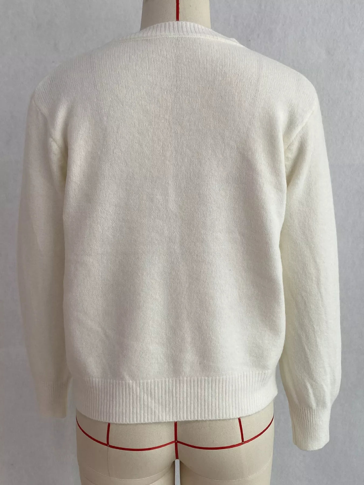 White round-neck button-front knit cardigan, back on dress form.