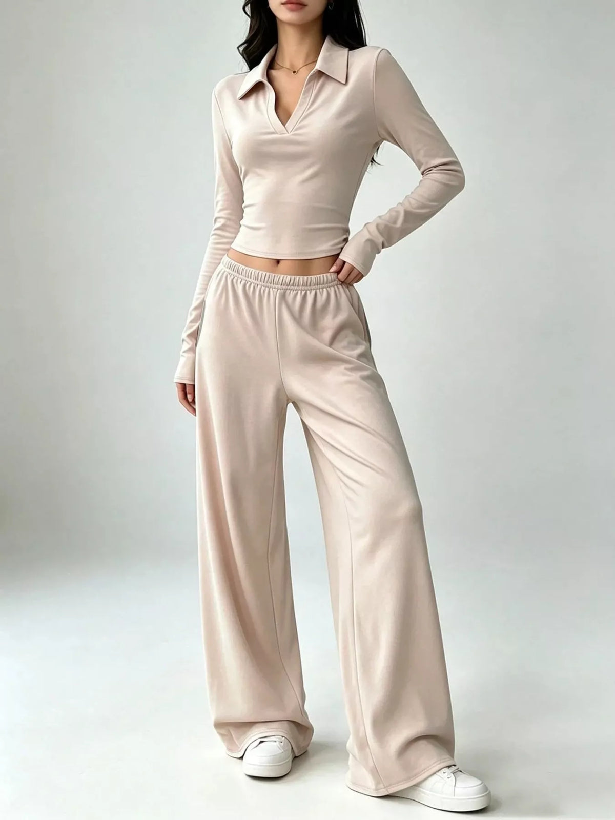 Beige collared crop top and wide-leg pants set, front view with hand at hip