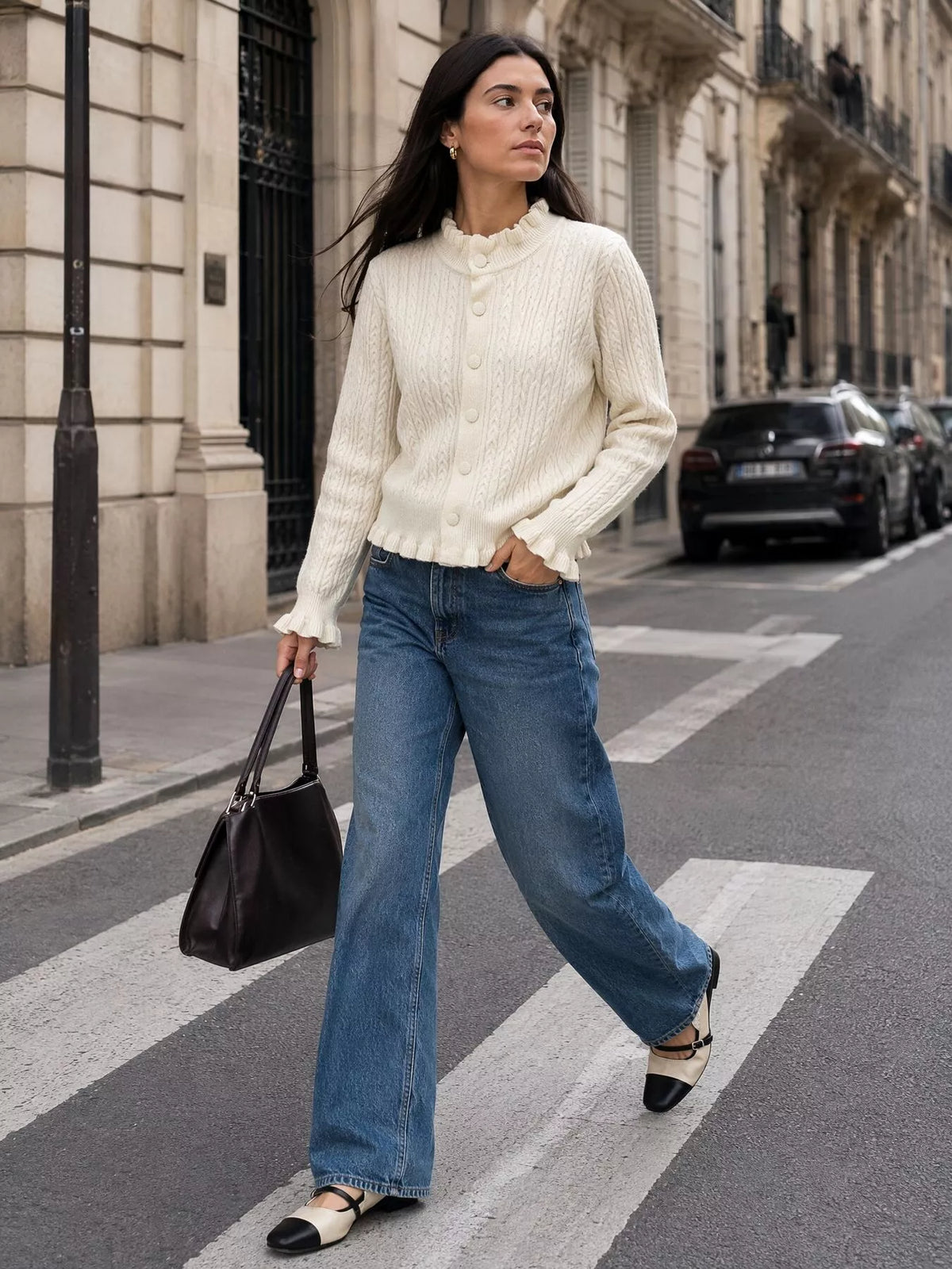 Ivory cable-knit ruffle-trim cardigan, walking front view.