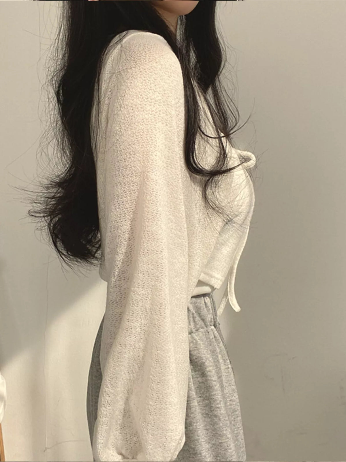 Round neck long sleeve cardigan, side view