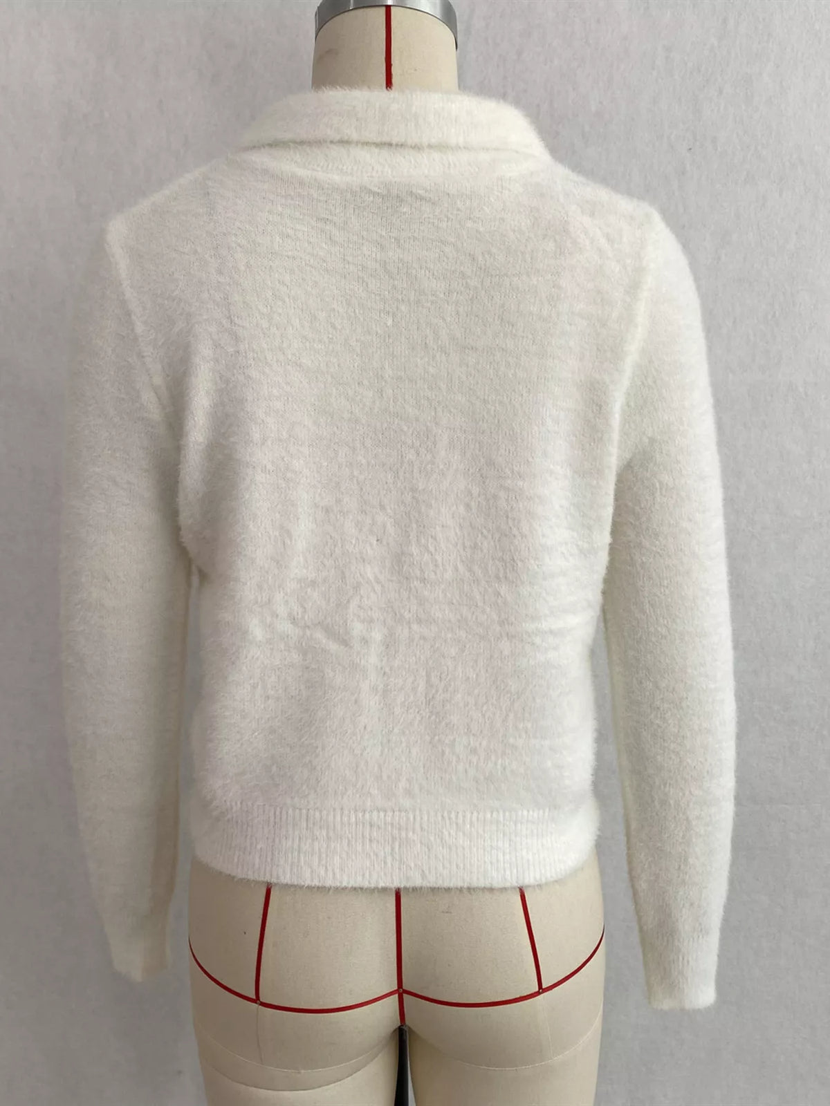 White fuzzy letter zip-up cardigan, back on dress form.