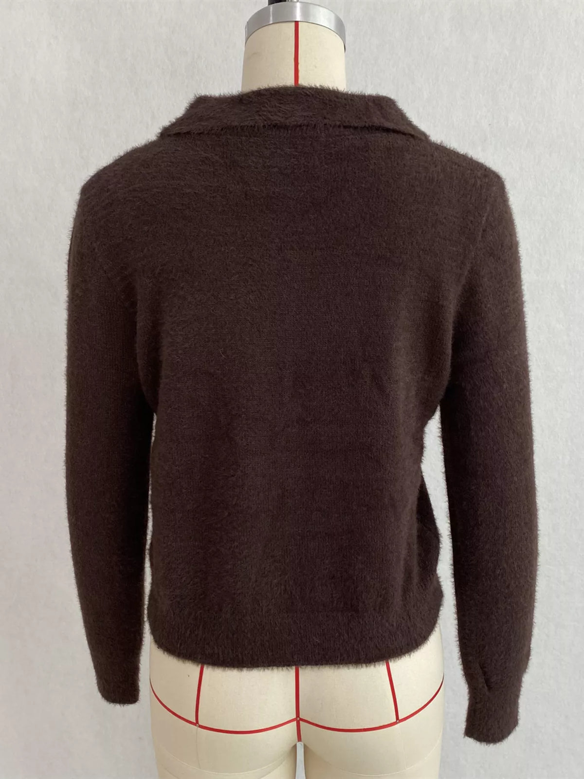 Brown fuzzy letter zip-up cardigan, back on dress form.