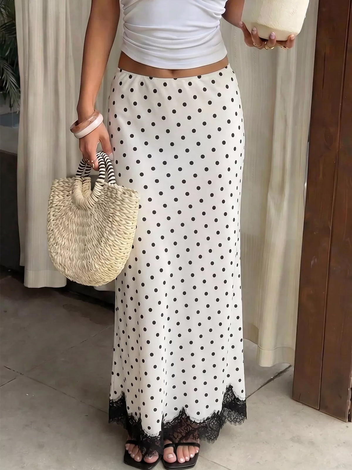 White and black polka dot high-waisted maxi skirt with black lace hem