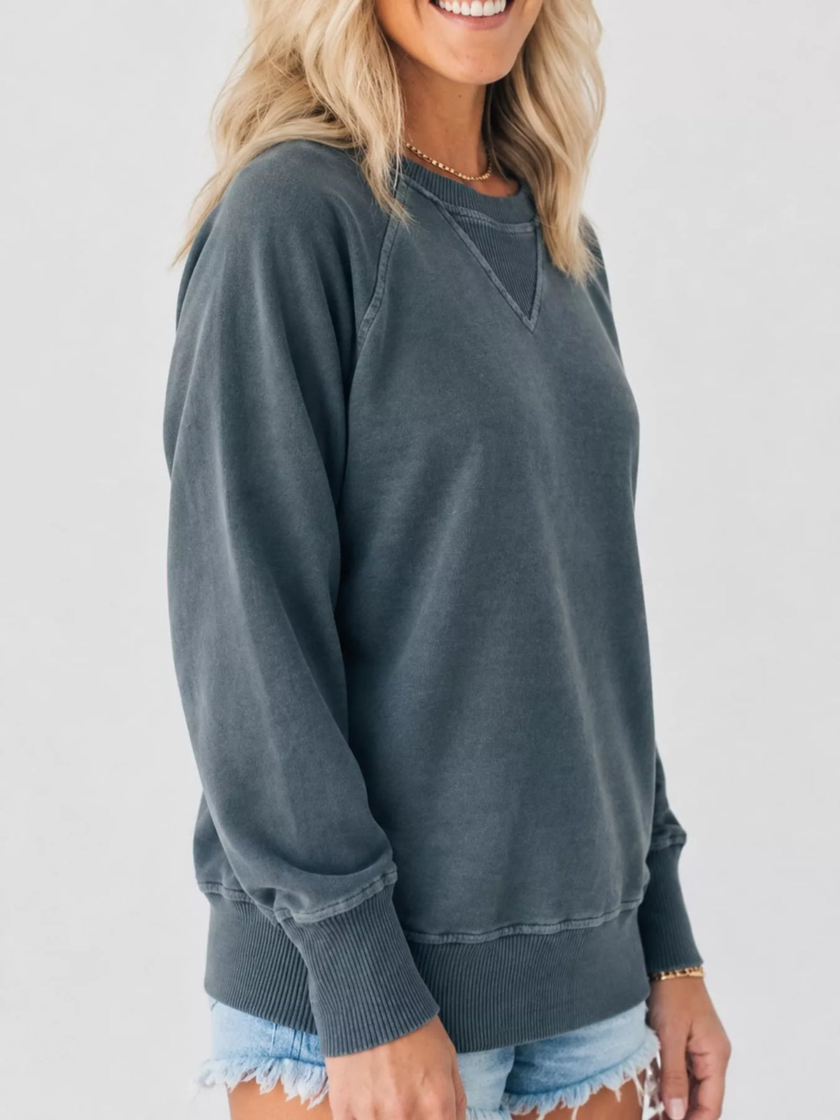 Blue-gray crew neck raglan sleeve sweatshirt, side view