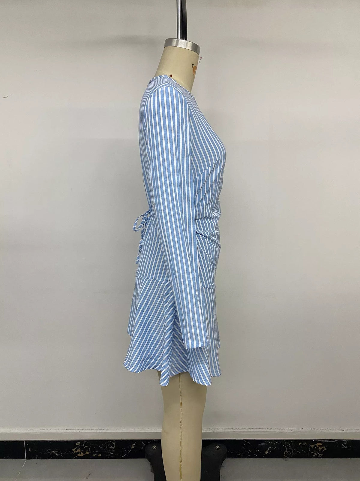 Blue striped long sleeve mini dress, side on mannequin