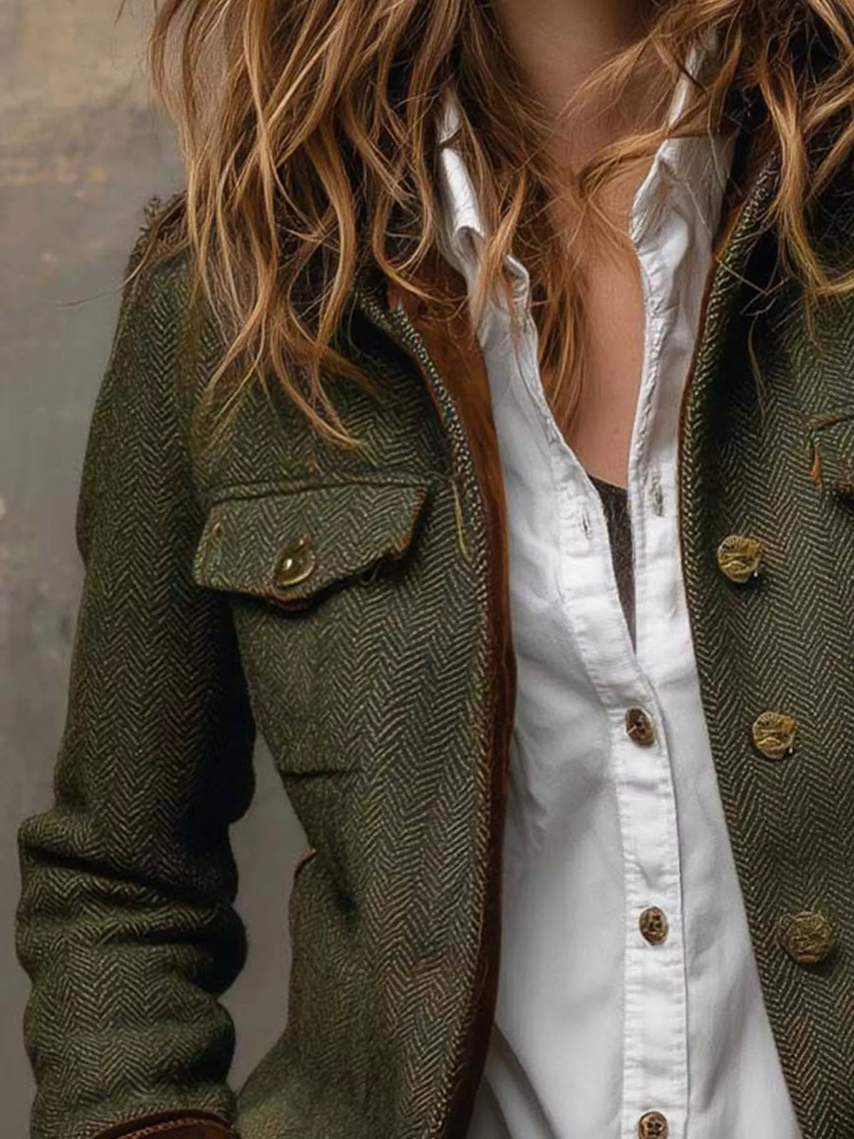 Green herringbone tweed blazer with velvet cuffs, flap chest pocket, buttons, and herringbone texture