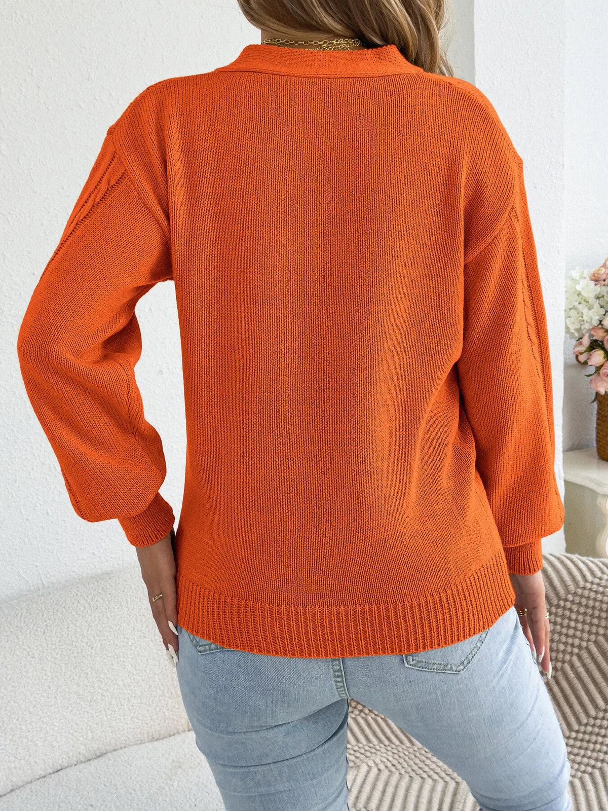 Orange cut-out cable knit sweater, back view