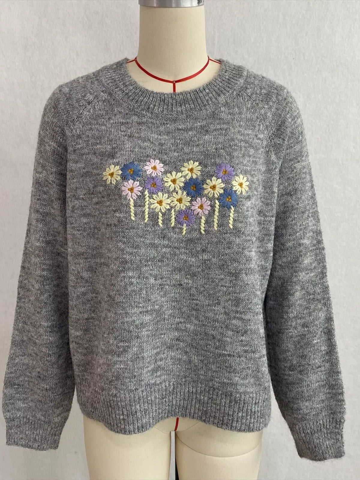 Floral embroidered round-neck sweater in gray, front mannequin view