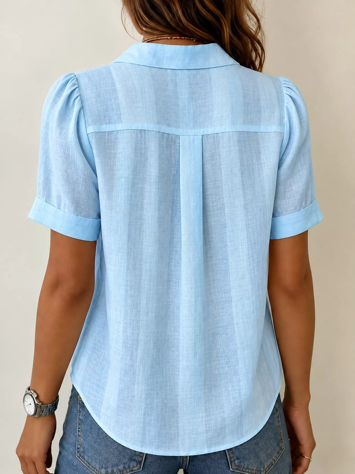 Blue button up short sleeve shirt, back view