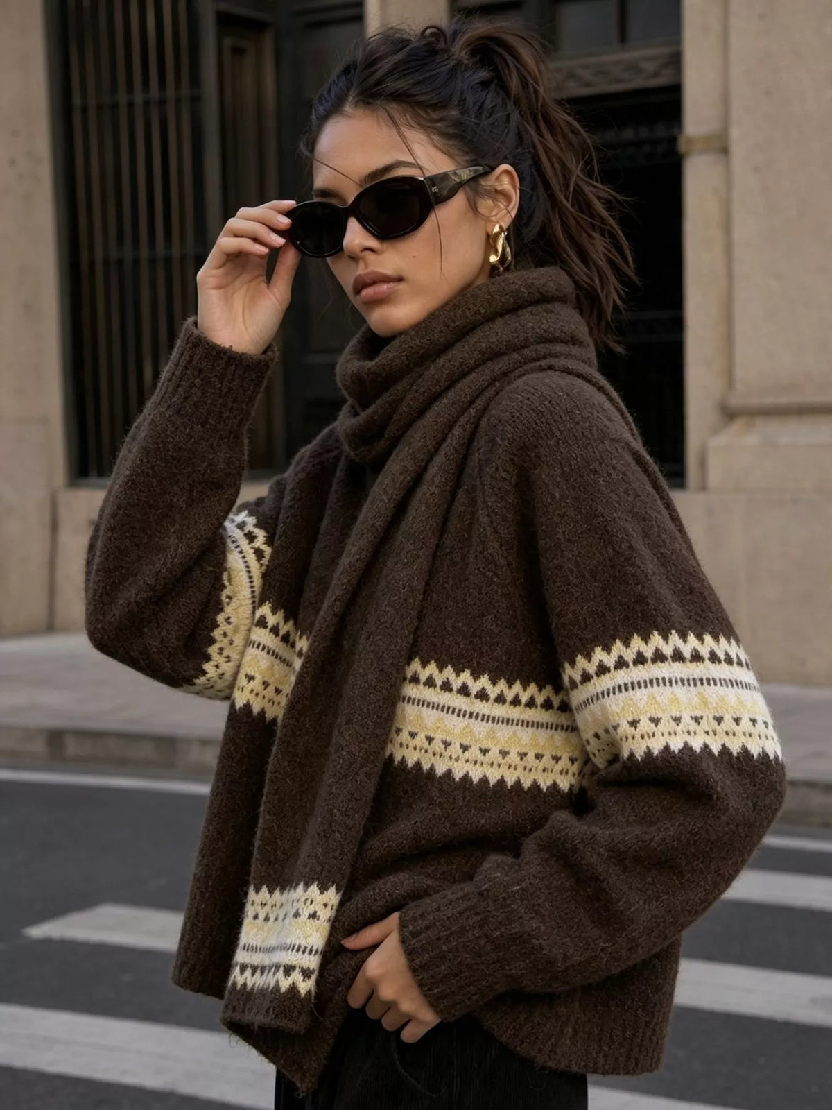 Brown geometric button-front knit cardigan, angled front view.