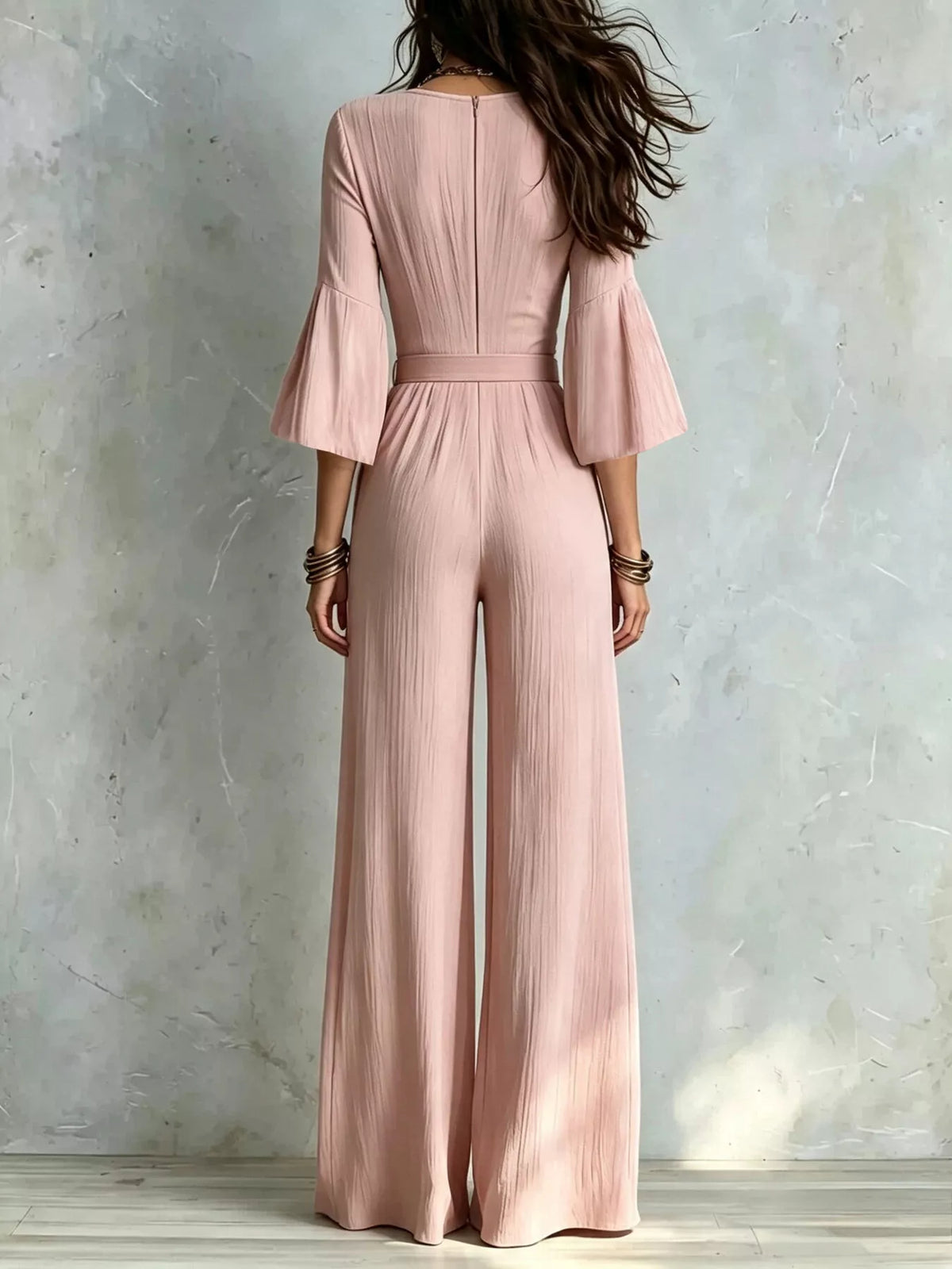Pink pleated wide-leg jumpsuit with tie-waist, back view