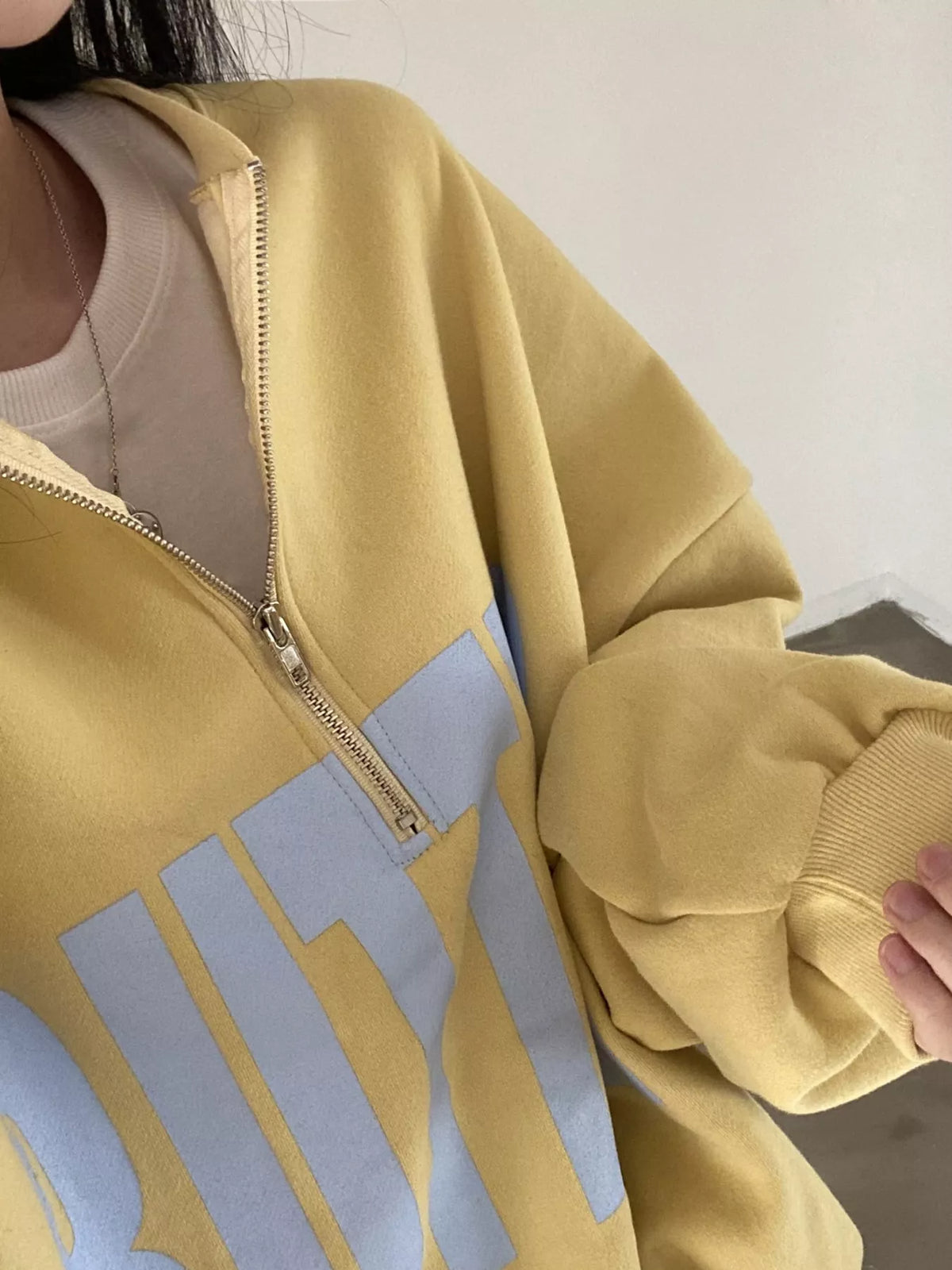 Women's Half-Zip Letter Graphic Sweatshirt in yellow — neckline detail view