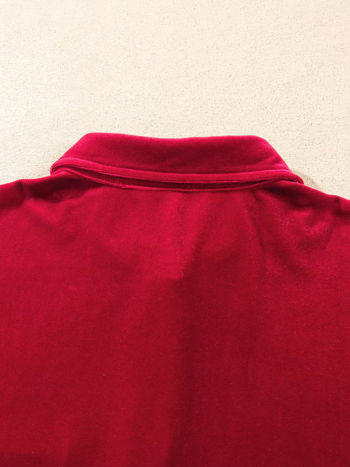 Back collar on red velvet button-down shirt with patch pockets