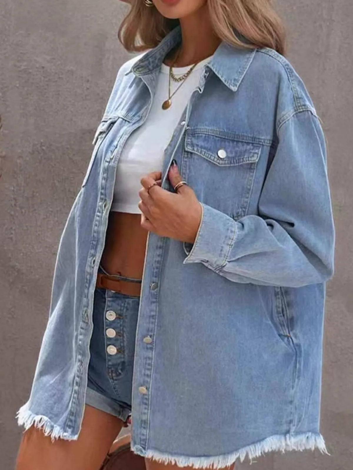 Women's Raw Hem Button Up Denim Jacket in light blue — side view