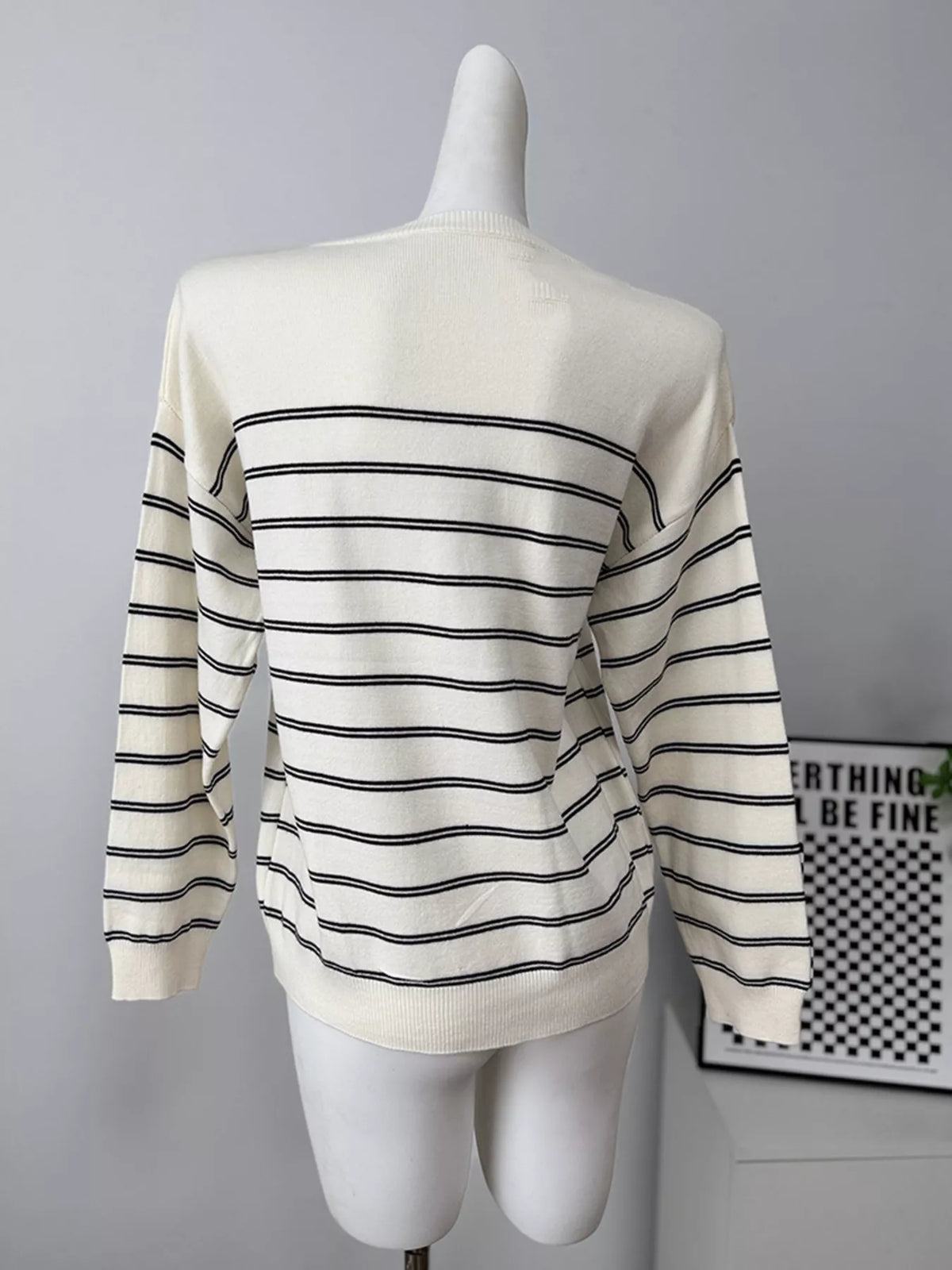 Striped crewneck sweater with layered tie detail in white and black, back without tie detail