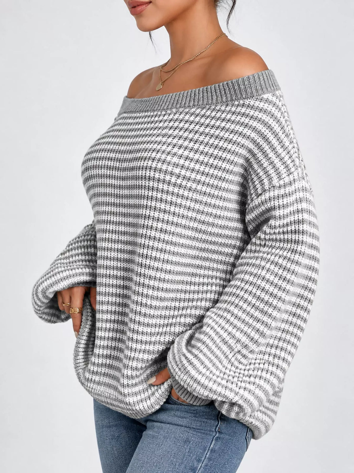 Gray and white striped knit boat neck sweater, side view