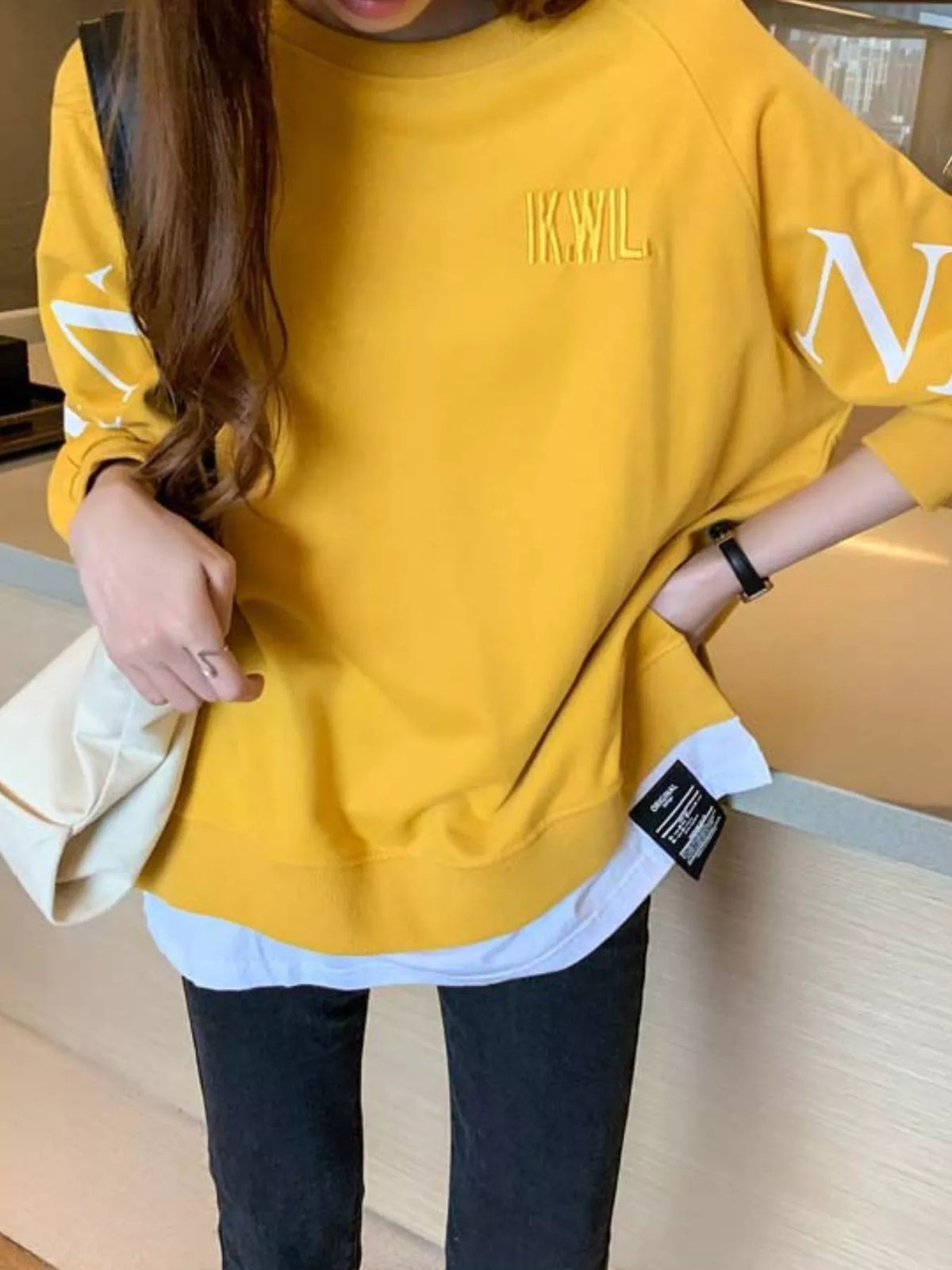Yellow layered-hem sweatshirt with graphic sleeve detail