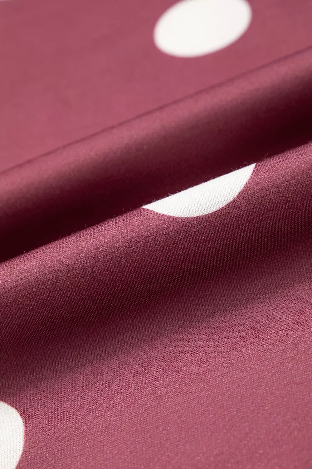 Burgundy polka dot tunic sweatshirt, fabric print close-up