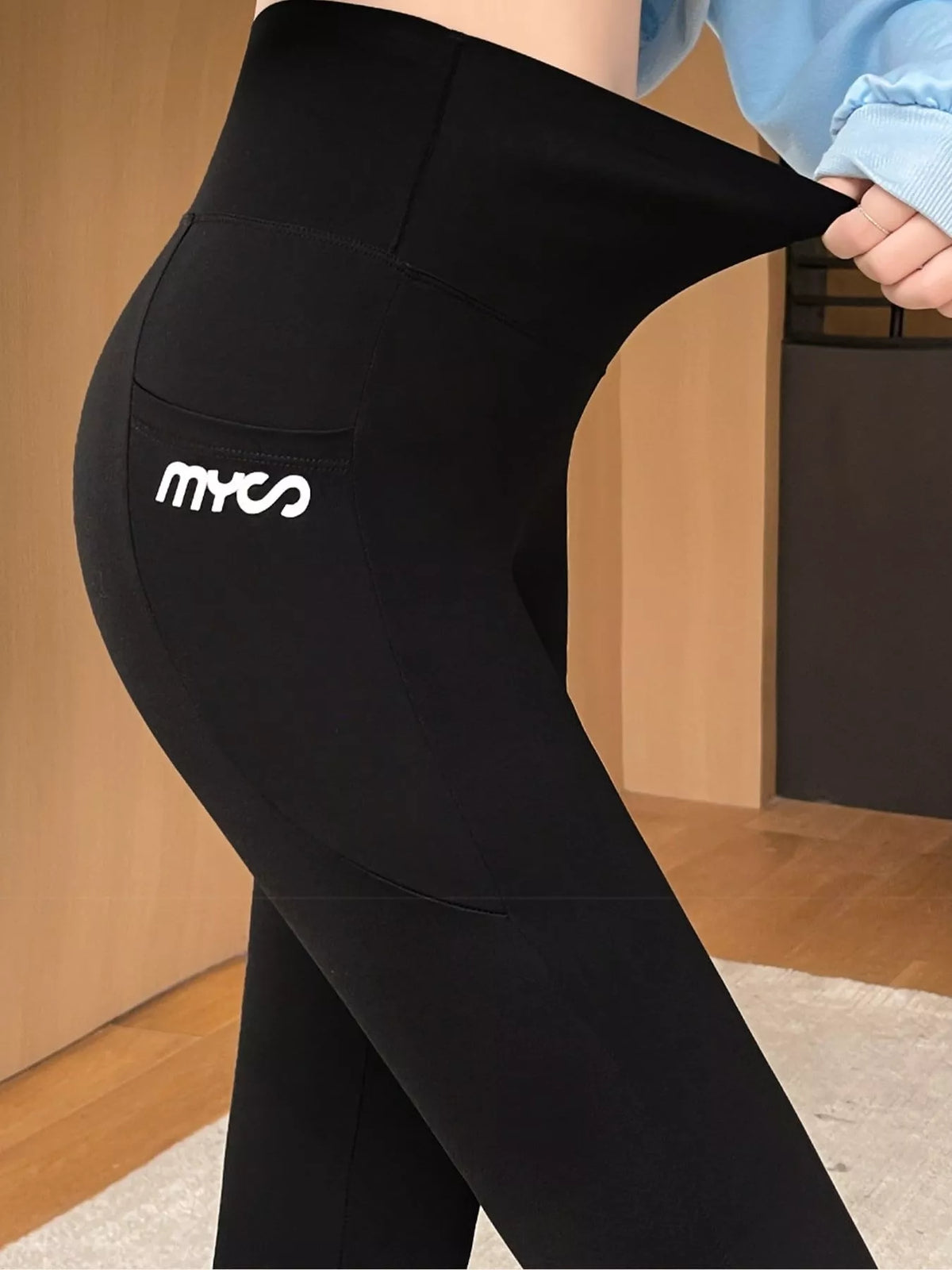 Women's High-Waisted Active Leggings with Side Pockets in black — waist detail view