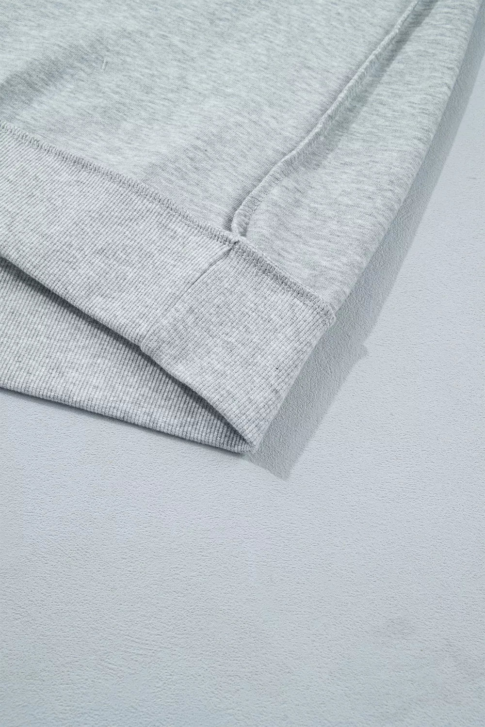 STATE Graphic Exposed Seam Mock Neck Sweatshirt in gray, cuff detail